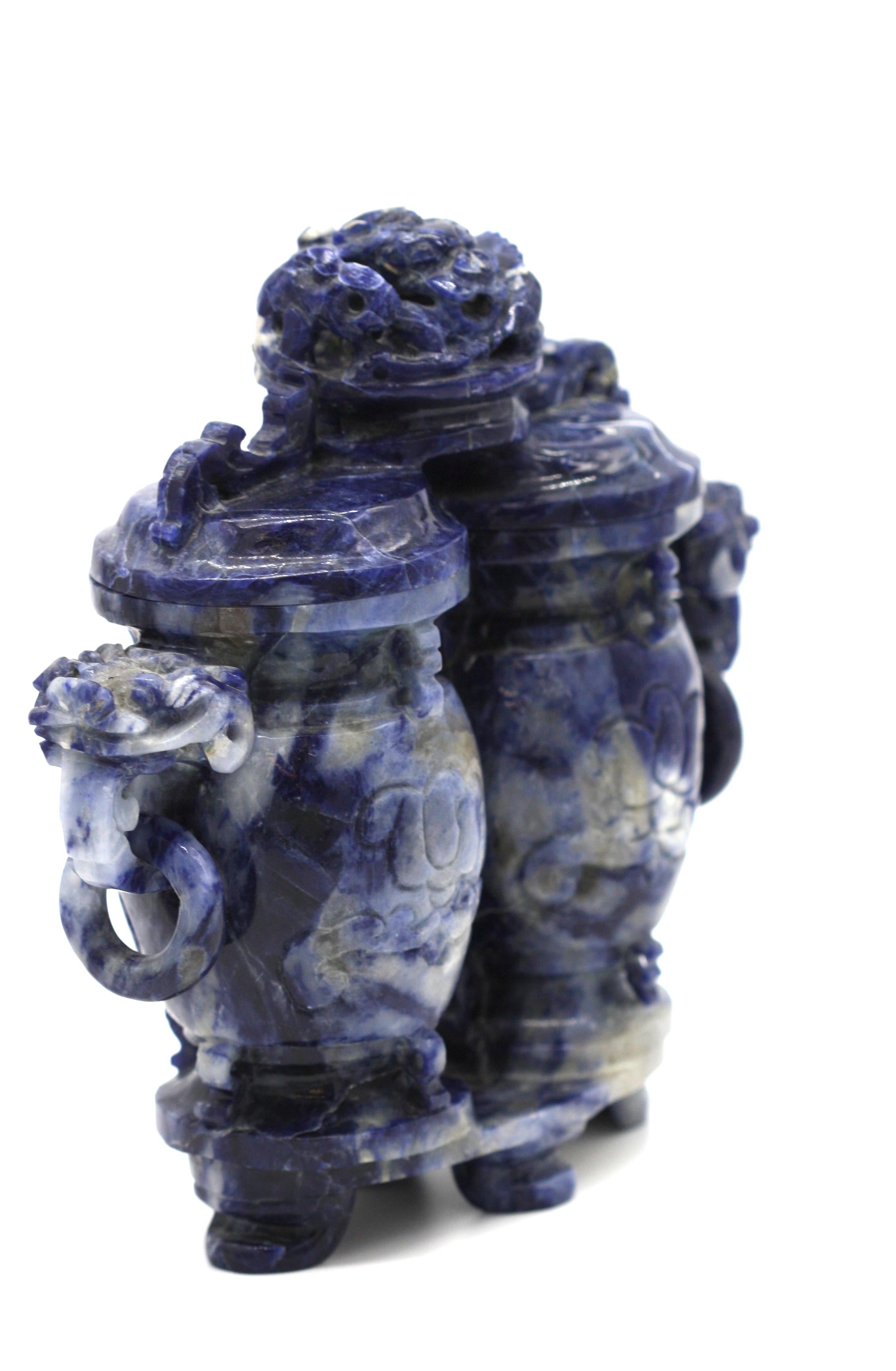 A Chinese carved Sodalite Archaistic vessel, 19th / 20th century, of archaic fanglei form and double round section, each side carved in relief with a taotie mask, the shoulders flanked by handles formed from the heads of mythical beasts, the cover