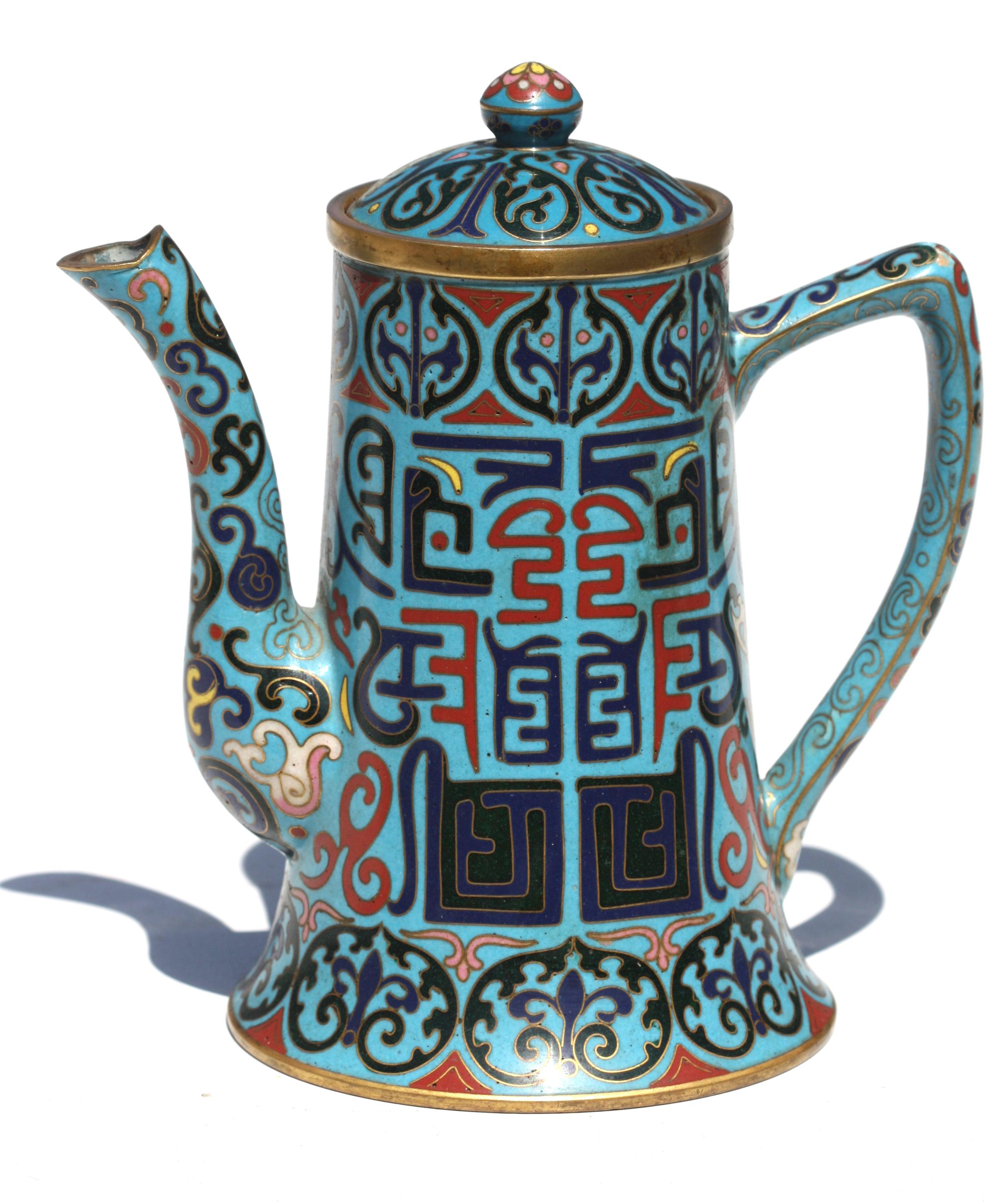 A Chinese Cloisonné enamel teapot and cover
the body set to one side with a handle the other with a short upturned spout
Measures: Height 6.5 in. (16.51 cm.), 
Width 6.25 in. (15.87 cm.), 
Depth 4.12 in. (10.47 cm.)