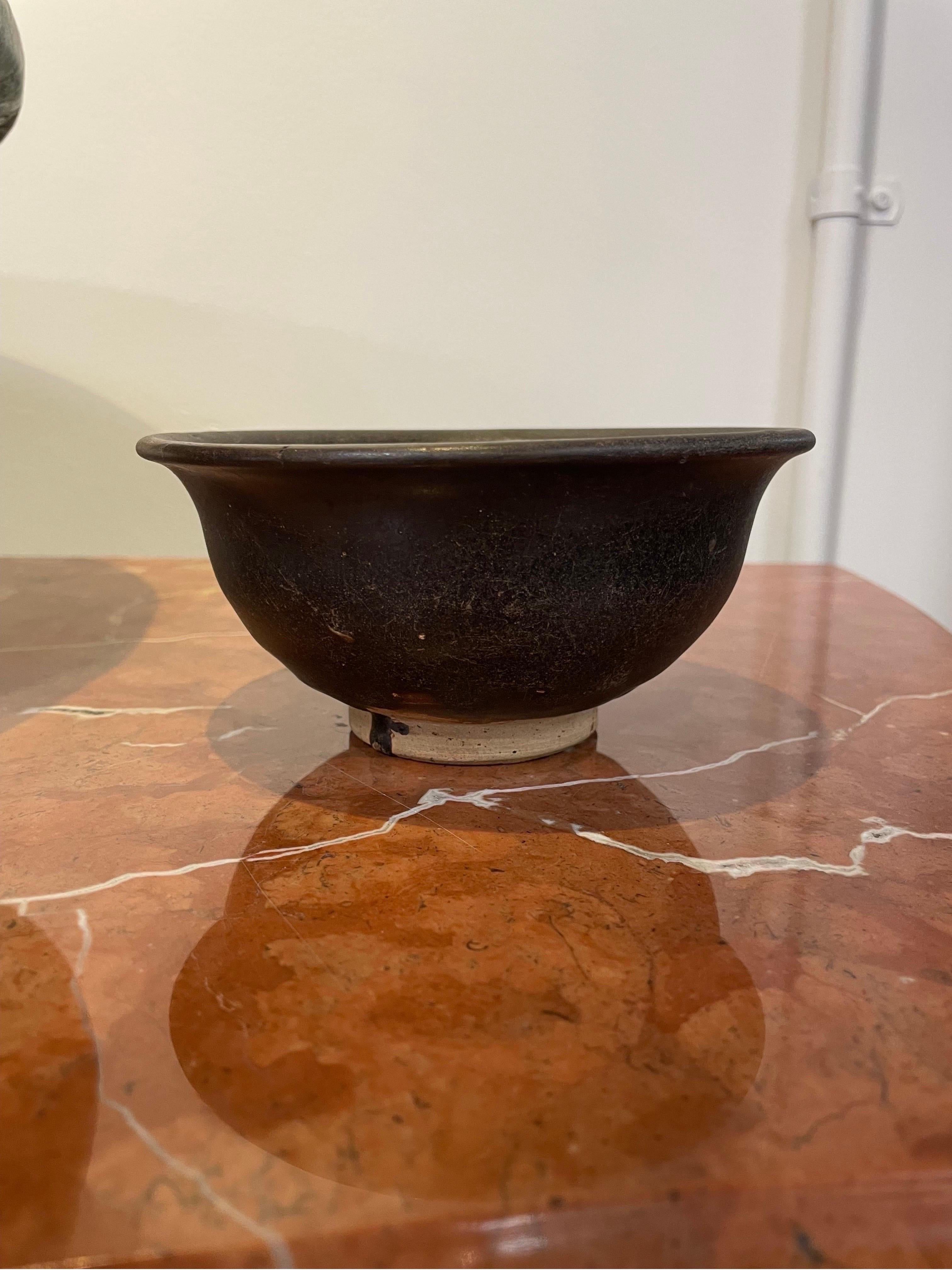 A Chinese Deep Brown Glazed Footed Bowl, 15th Century

Provenance: The Collection of Dr. John Yu AC

Dimension: Height: 7.3 cm. Dimension: 15.5 cm

Dr. Yu was the Founding Chair of VisAsia in the Art Gallery of New South Wales and is a Life Governor