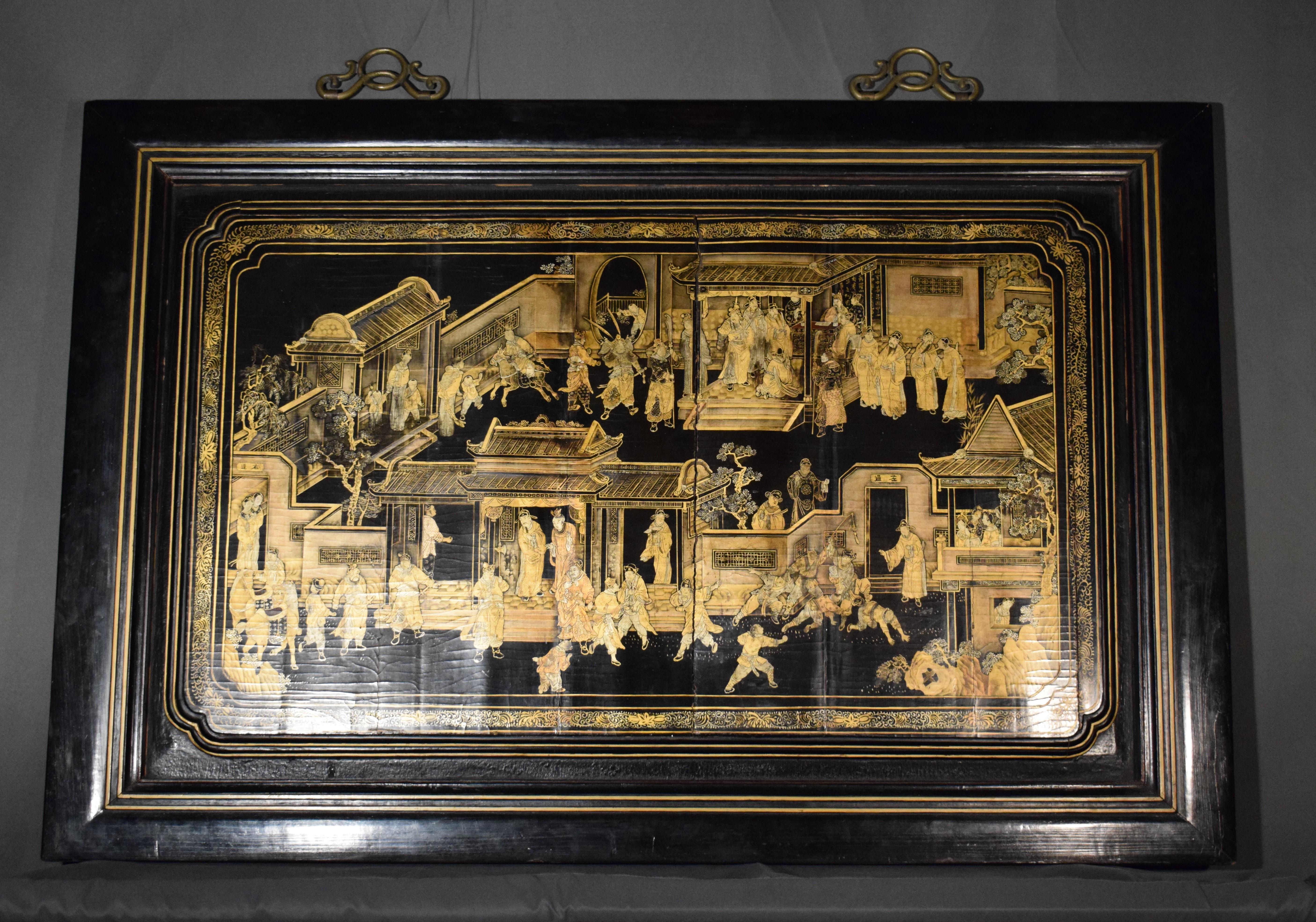 A Chinese export gilt-decorated black lacquer panel
19th century
The rectangular panel with inset rounded corners, finely decorated with figures at various pursuits on a black ground, mounted in an ebonized wood frame.
Dimensions of panel 28 x 46