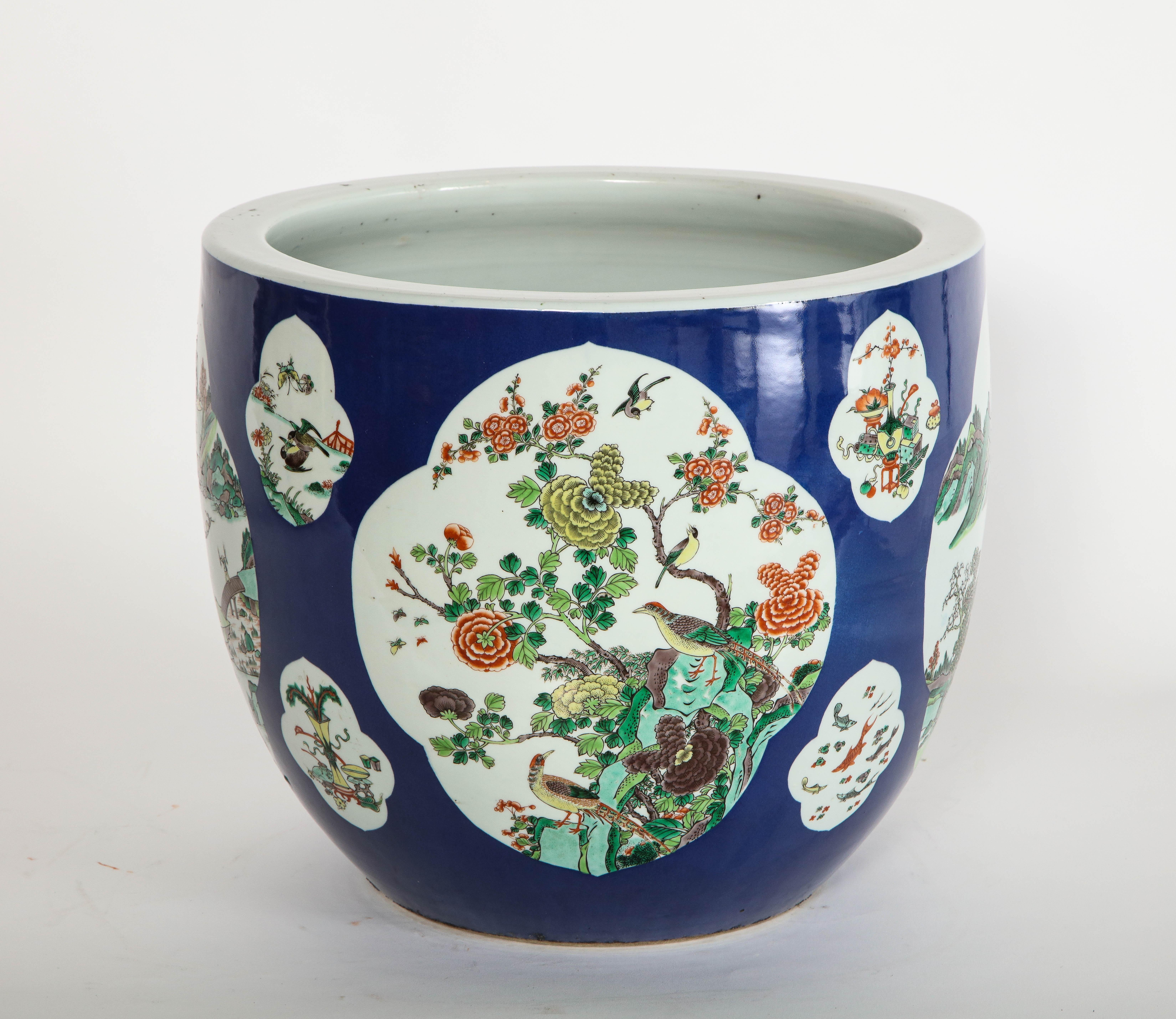 A beautiful and quite large 19th century famille vert blue-ground planter with gorgeous landscape cartooges and floral scenes. This planter is exquisitely hand painted with elaborate Chinese panel cartooges of four main landscape scenes, as well as