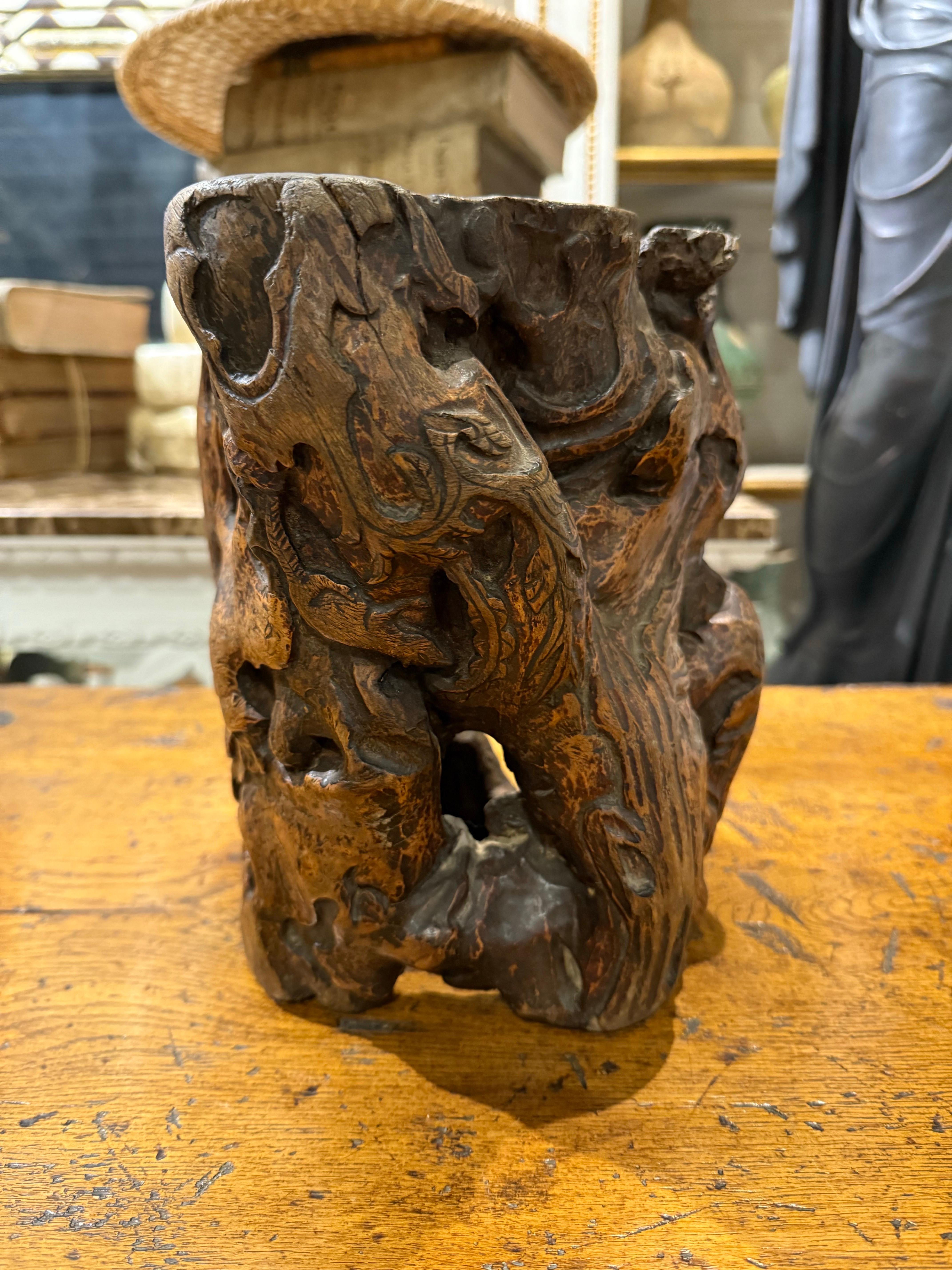 A Chinese Hardwood Gnarled Root Brush Pot, Late 19th Century

This decorative container is used to hold writing brushes and popular during the Qing dynasty (1644–1911). It was revered for its organic, wild appearance, evoking the image of an