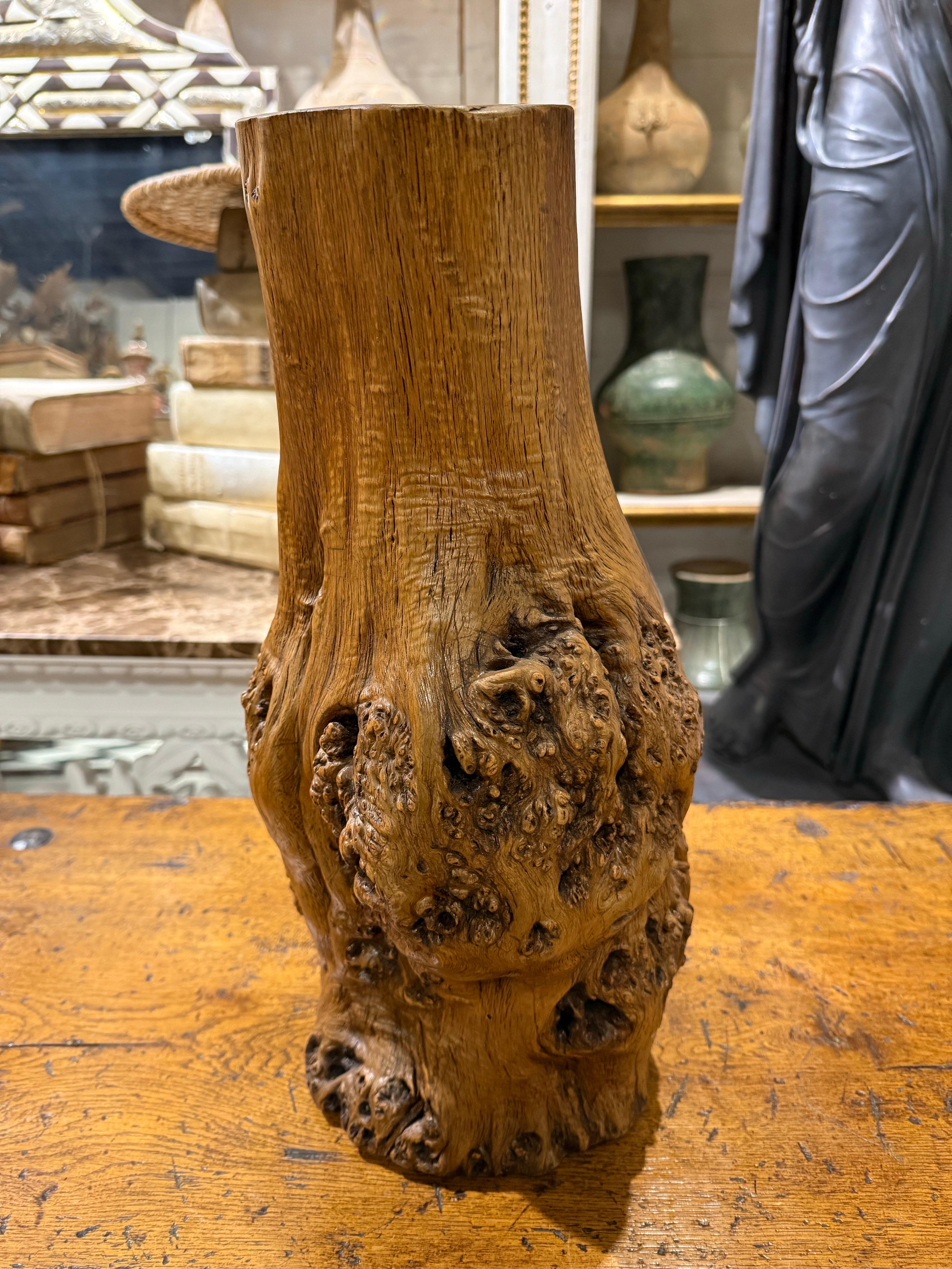 A Chinese Hardwood Gnarled Root Brush Pot, Late 19th Century

This decorative container is used to hold writing brushes and popular during the Qing dynasty (1644–1911). It was revered for its organic, wild appearance, evoking the image of an
