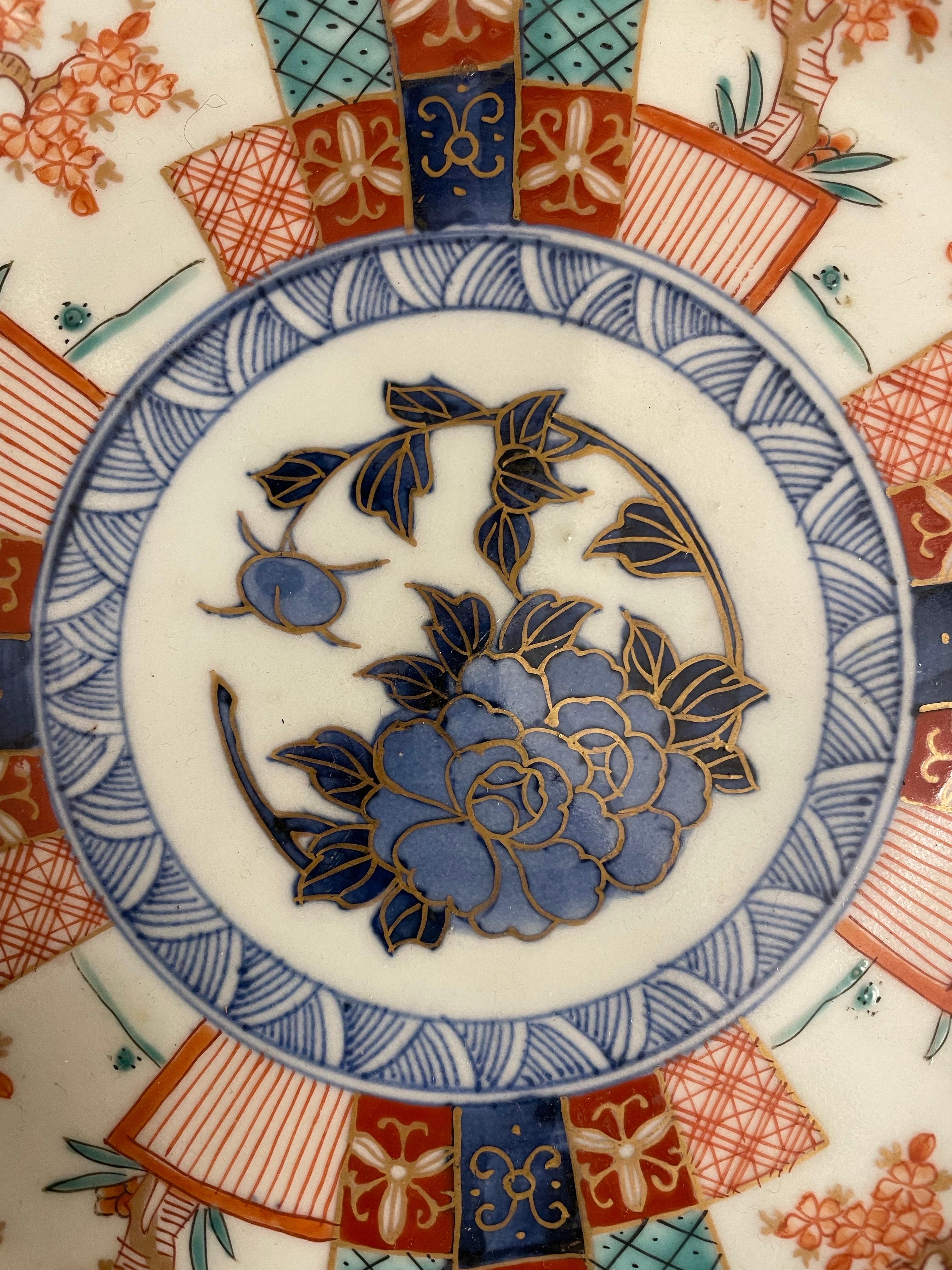 A Chinese Imari Style Plate with Chenghua Mark, 19th century

Provenance: Private Victoria Collection.

Description:
the central design comprising an unfurling blossom in hues of cobalt with gilded borders, to cobalt band surrounded by alternating