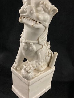 A Chinese Kangxi Period Porcelain Blanc de Chine Foo Dog, circa 1680