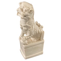 A Chinese Kangxi Period Porcelain Blanc de Chine Foo Dog, circa 1680