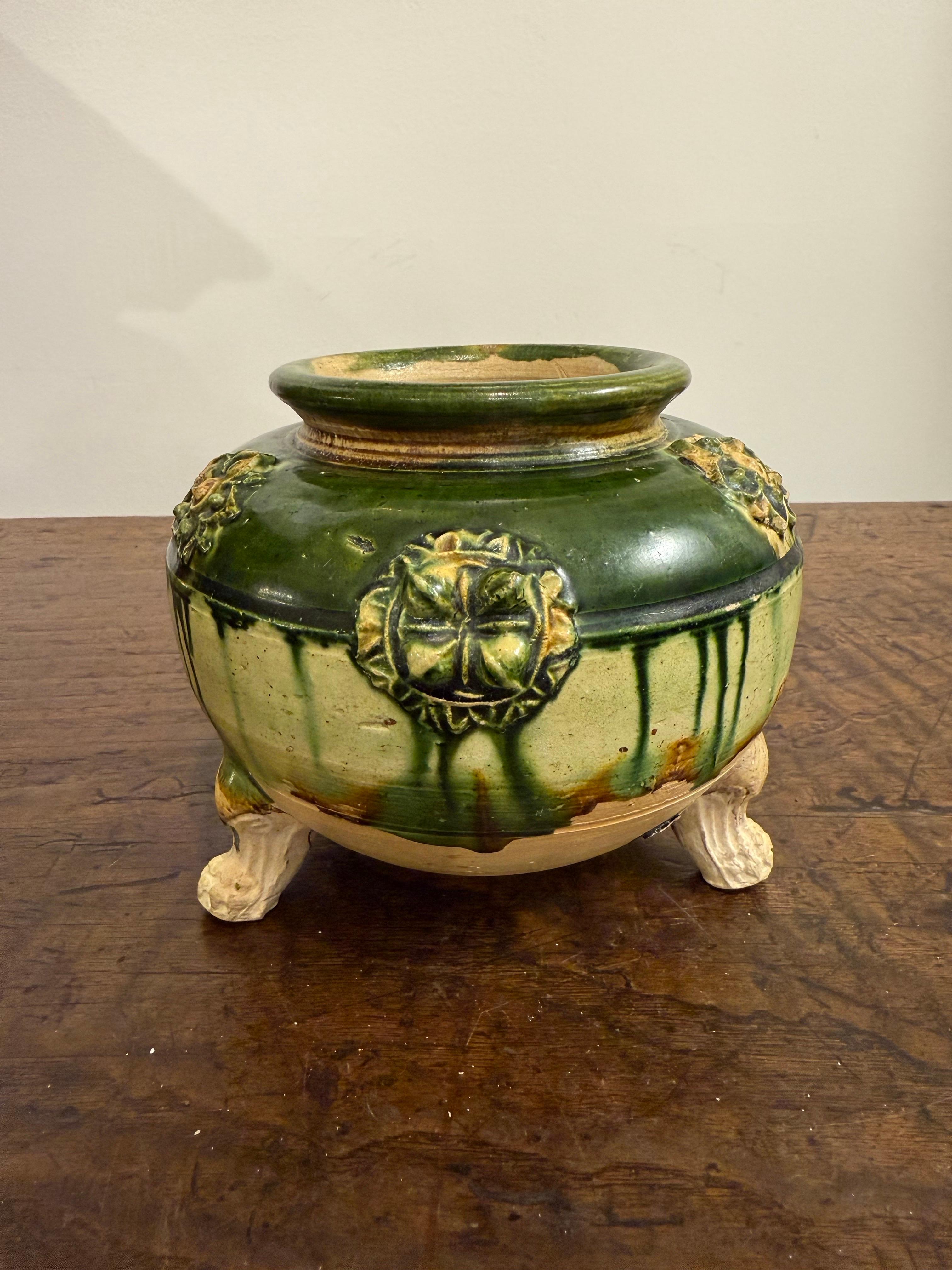 A Chinese Sancai Tripod Jar, Tang Dynasty

The globular body is supported on three claw feet and is covered in a splashed-glaze of amber, green and cream color, which stops short of the unglazed base.

Provenance: Sotheby's New York