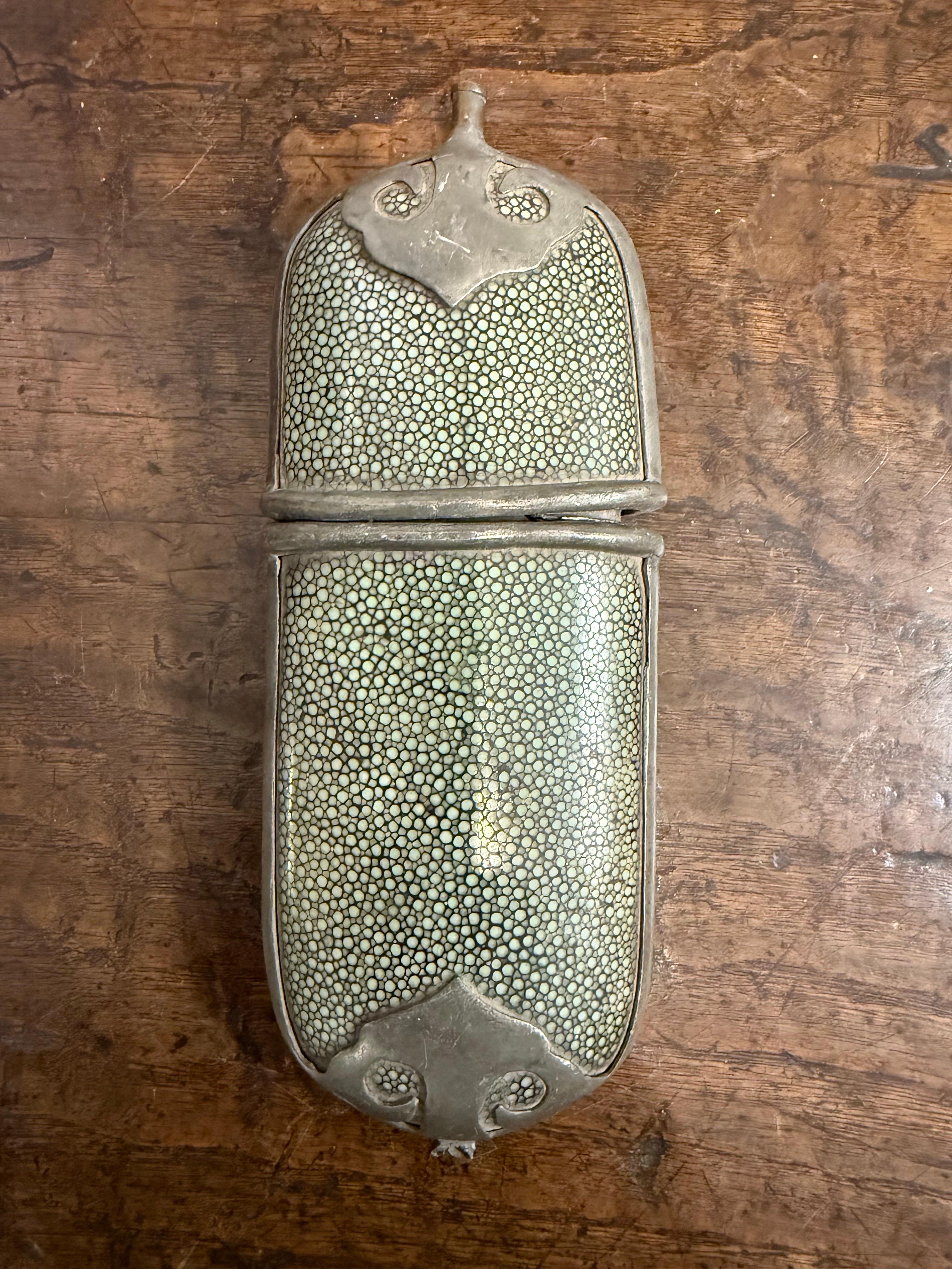 A Chinese Shagreen Style Glasses Case, 19th Century

This Chinese spectacle case is carved from wood with a striking shagreen style covering. The case dates from the Qing Dynasty (1644–1911), still in wonderful condition with a rich deep color and