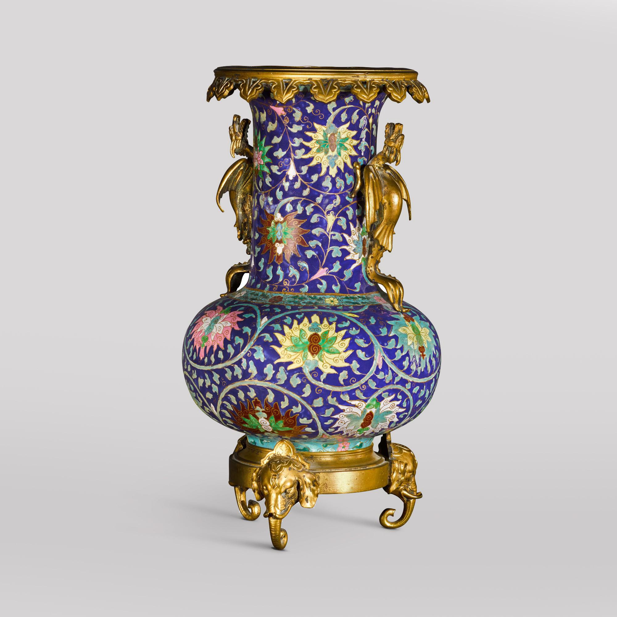 A Gilt-Bronze Mounted Chinese-Style Porcelain Vase With Dragon Handles and Elephant Head Feet, In the Manner of Ferdinand Barbedienne. 

French, circa 1860.
