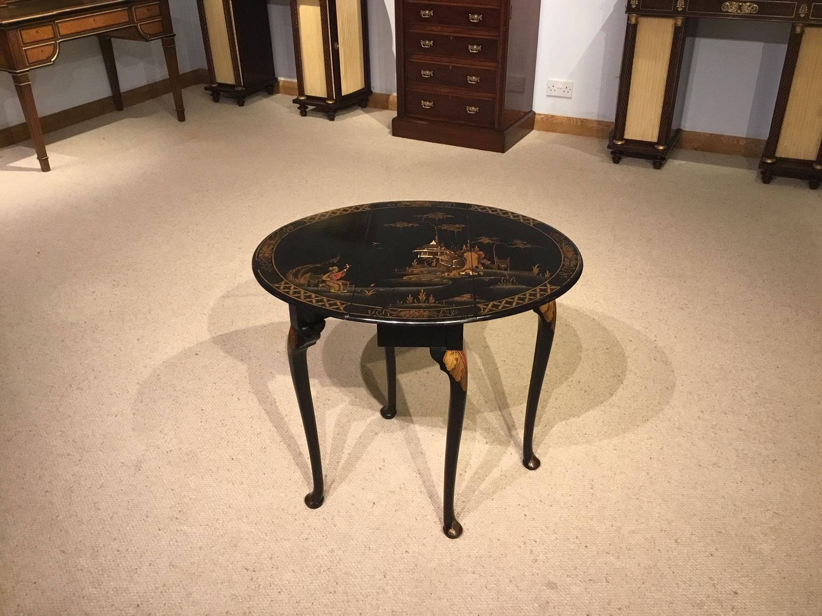 A chinoiserie lacquered 1920s drop leaf table. Having an oval top with twin drop leaves decorated in lovely raised lacquer depicting typical oriental landscape. Supported on elegant cabriole supports with pad feet. English in the Chinese taste,