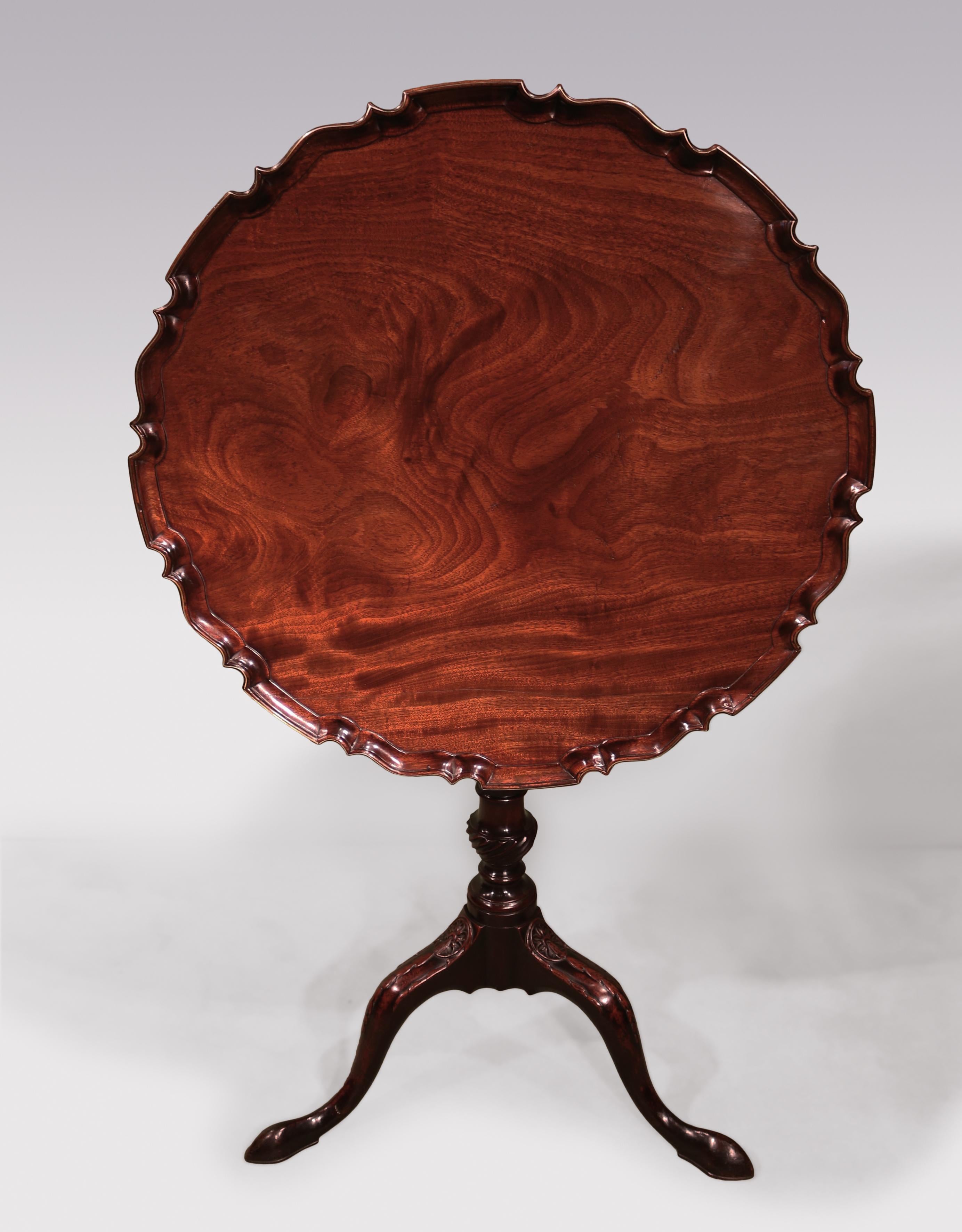 A fine quality mid-18th century Chippendale period well-figured mahogany tripod table, having well carved circular piecrust edge with unusual brass line inlay, supported on spiral twist gun-barrel stem ending on roundel and husk carved legs.