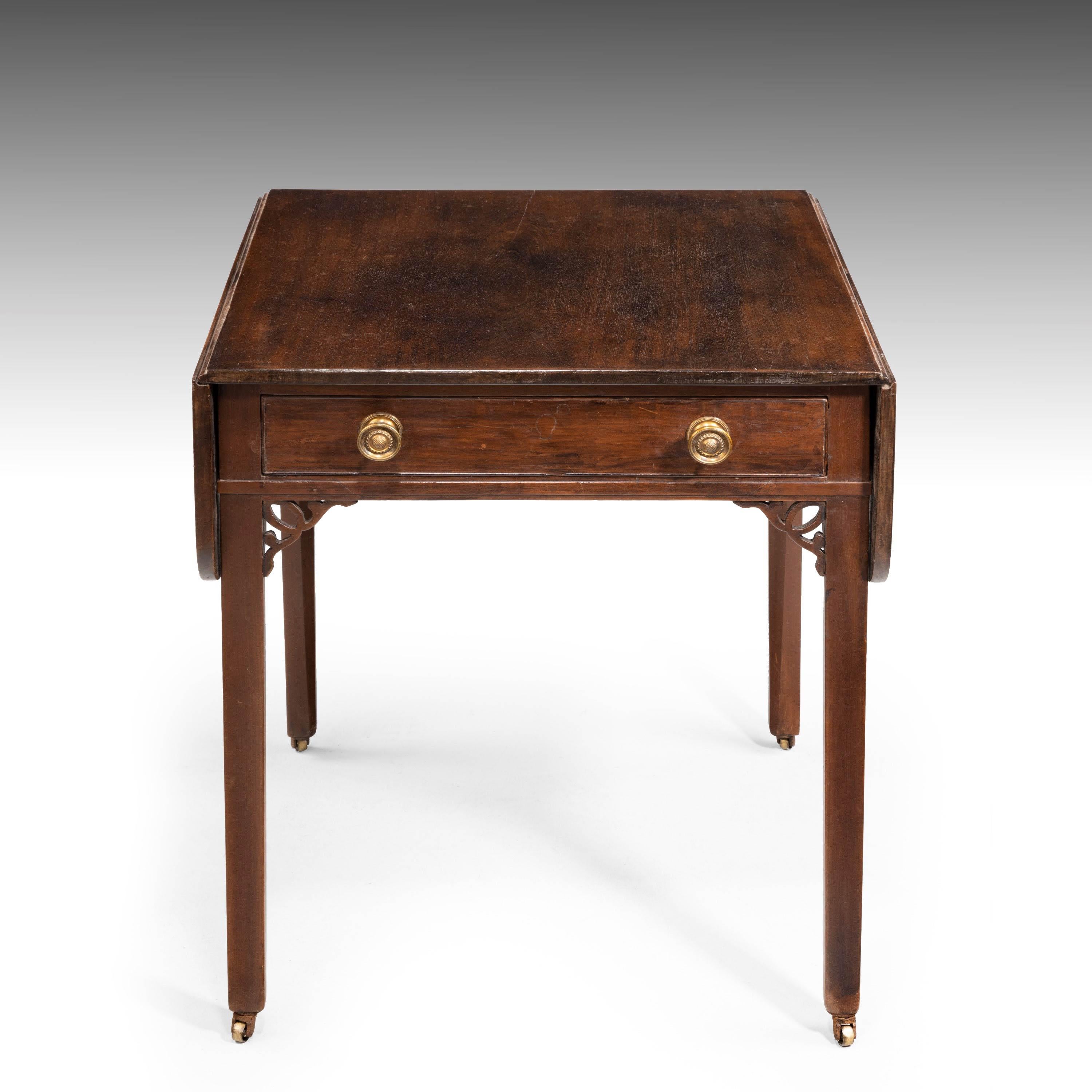 A Chippendale period mahogany Pembroke table on square supports. With an attractive carved original corner decoration. Period handles to the drawers with the reverse being a blind drawer.
Measures: Open width 41.5