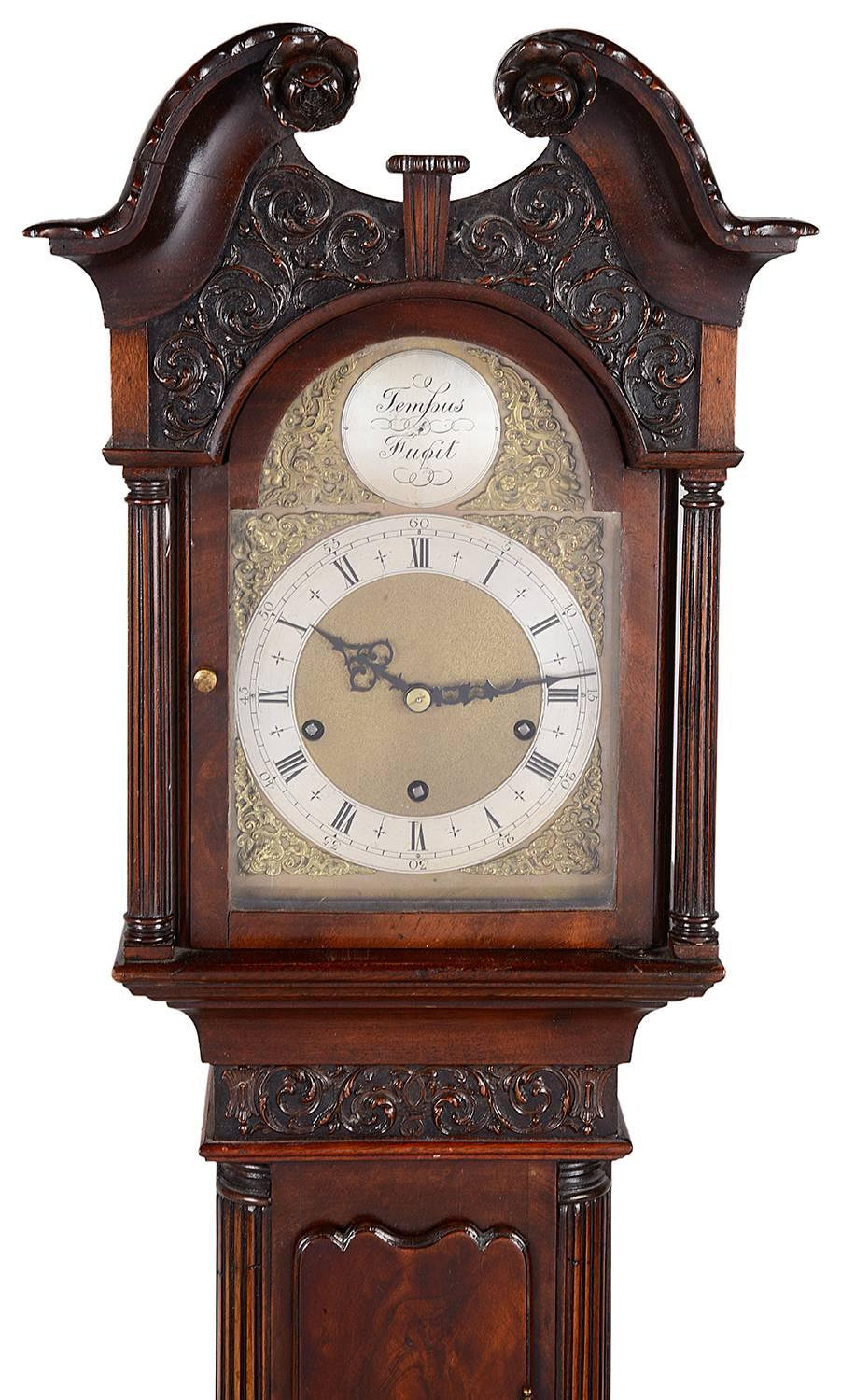 A very good quality Mahogany Chippendale style Grandmother clock, having a three train chiming movement, a figured Mahogany case with carved fretwork and molded panels.