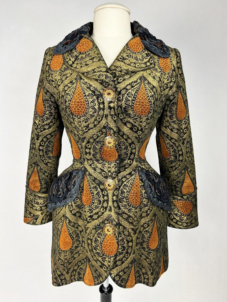 Circa 1990

France

A remarkable frock coat from the golden years of Christian Lacroix Haute Couture. Inspired by Mariano Fortuny, this black silk velvet is finely printed with gold and coral cypress motifs, celebrating the Italian Renaissance or