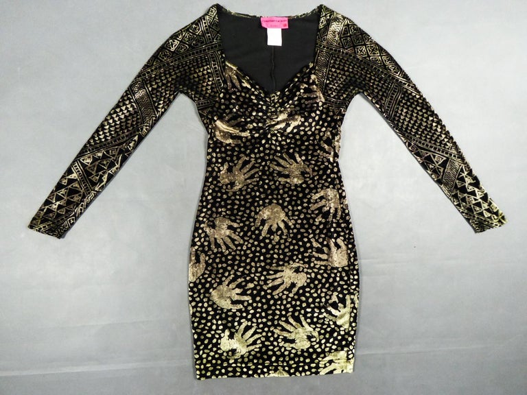 Circa 1991/2000
France

Beautiful skin-tight dress by Christian Lacroix in printed velvet dating from the 1990s. Iridescent stretch elasthane velvet with golden patterns on a black background. Ethnic print with geometric decor and handprints. Large