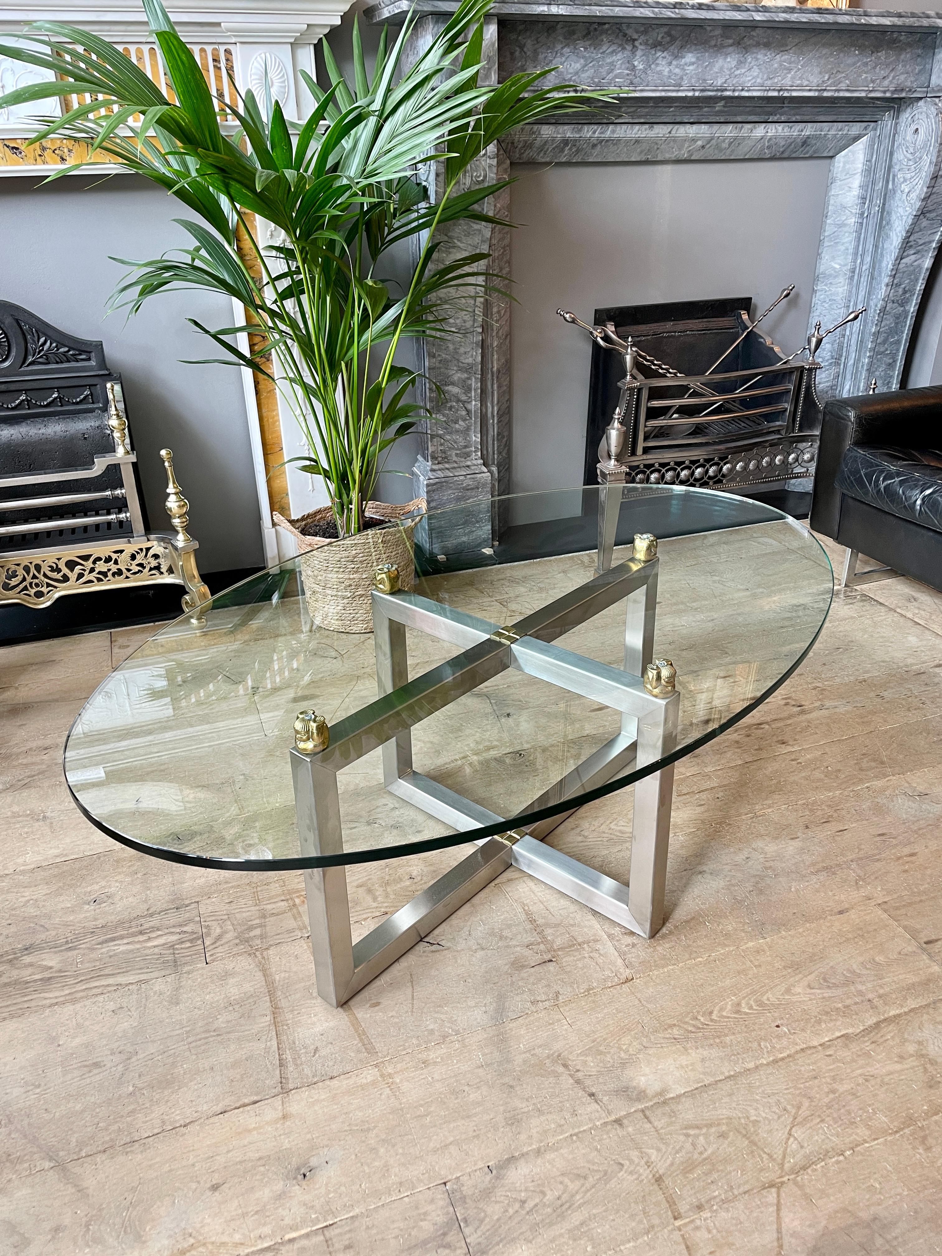 A Chrome table with thick oval glass top From the Biri range by Peter Ghyczy. A rare model with small heavy brass eastern figures supporting the glass top. A very good quality table by this designer.