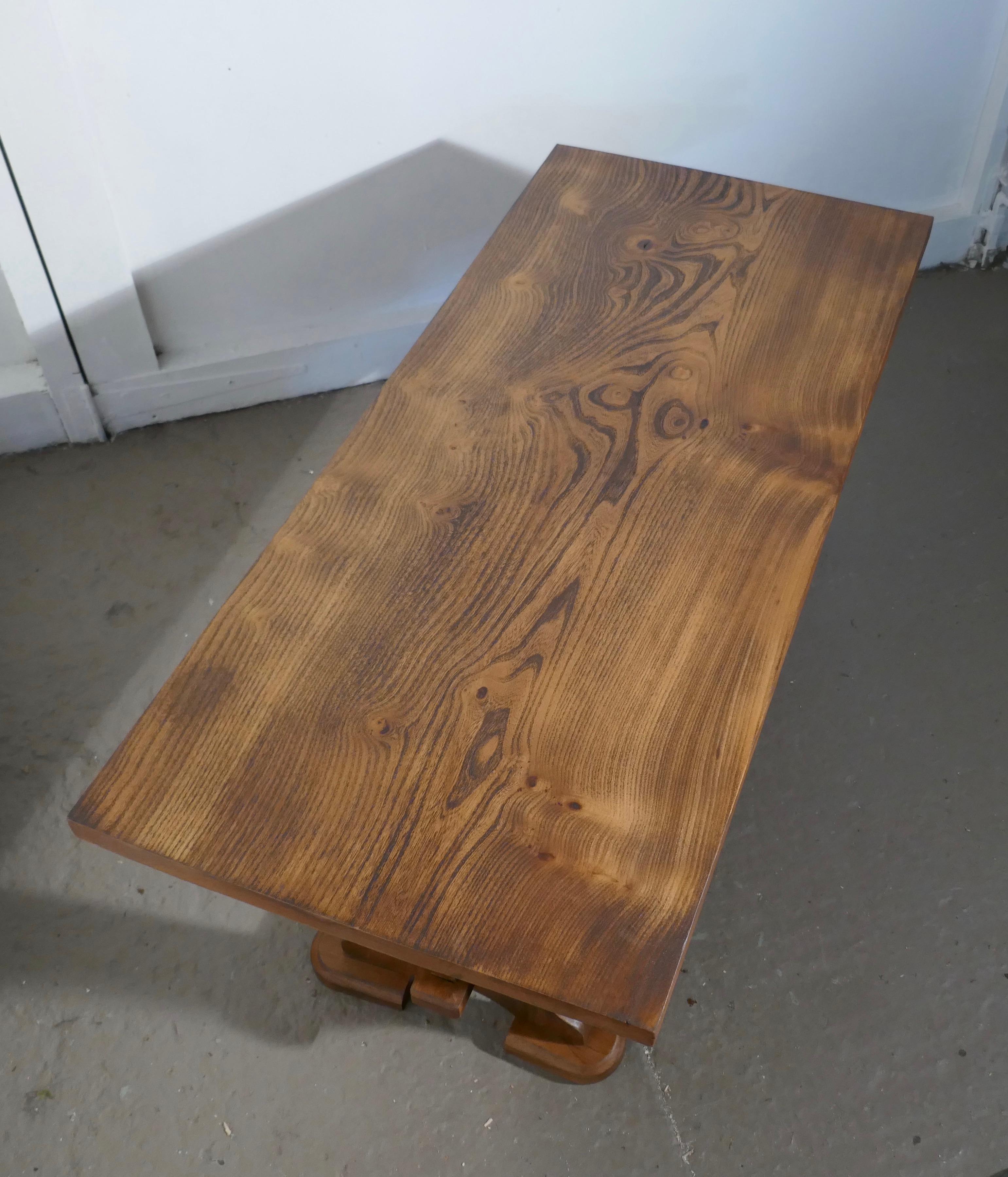A Chunky solid elm farmhouse coffee table

This is a very sturdy table, made in the farmhouse refectory style, it is made in solid elm which has a superb patina and an attractive grain it has a thick top and chunky legs 
The table is very good