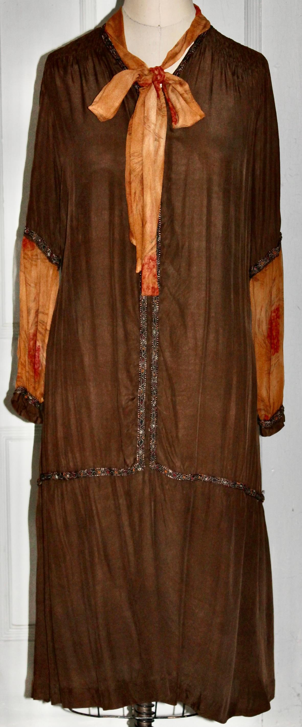 Offering a 20's Edwardian Style (dropped waist) 'Flapper Dress', silk with a braid trim.  Unmarked, but was purchased with (and included with) a matching brown velvet French Hat  with a Maria Guy 8 Place Vendome, Paris. label.