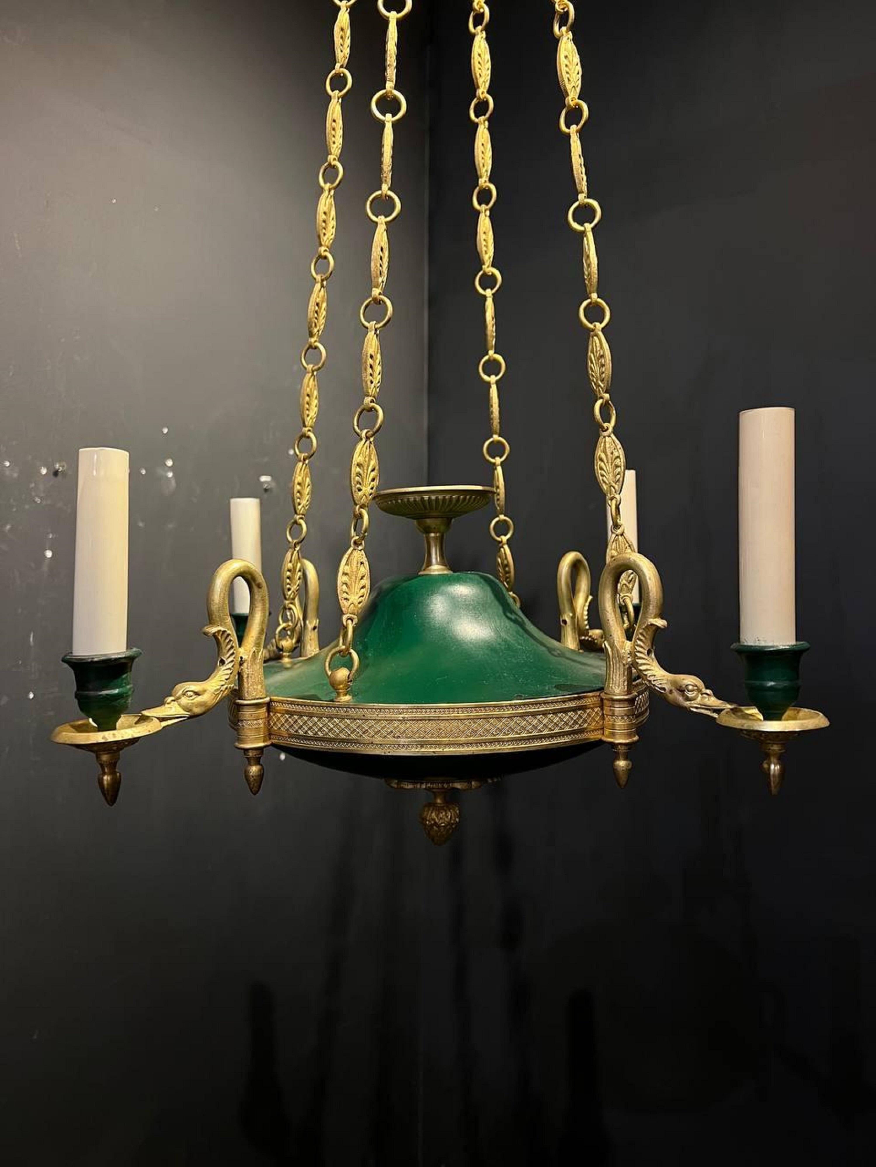 A circa 1900s gilt bronze with painted tile Empire style green chandelier with swans heads.

Dealer: G302YP.
 