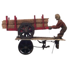 Circa 1910, Hand Carved Folk Art Assemblage Including a Man, Wagon, and Wood