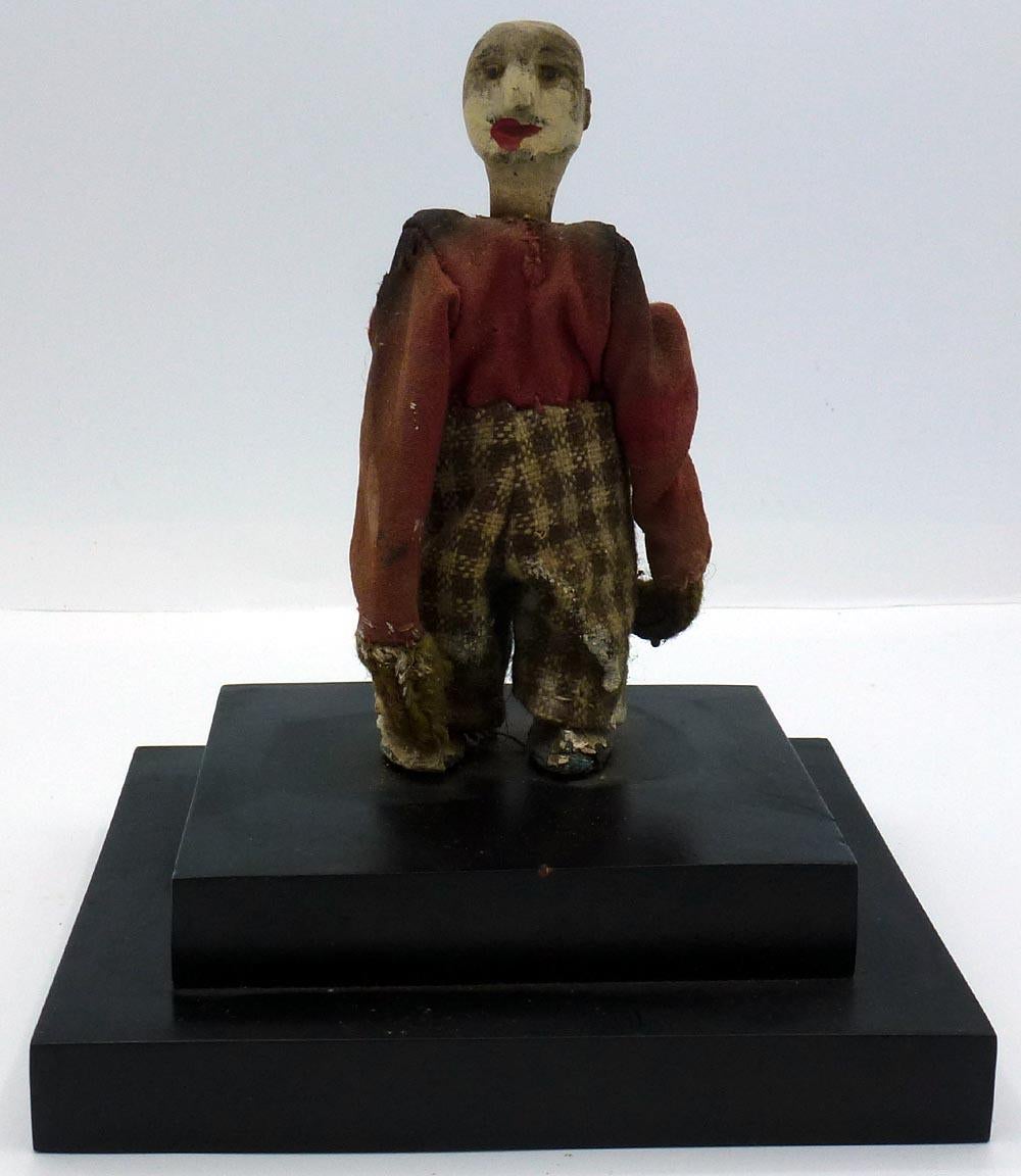 This is a hand carved Folk Art Man with a Red Shirt, Plaid pants: 5
