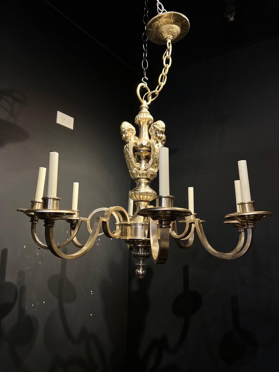 A pair of circa 1920's Caldwell silver plated chandelier with cherubs atop and 8 lights