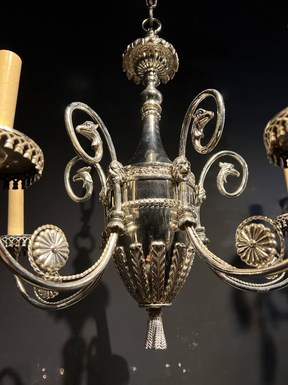 A circa 1900 Caldwell silver plated chandelier with lions and eagle heads