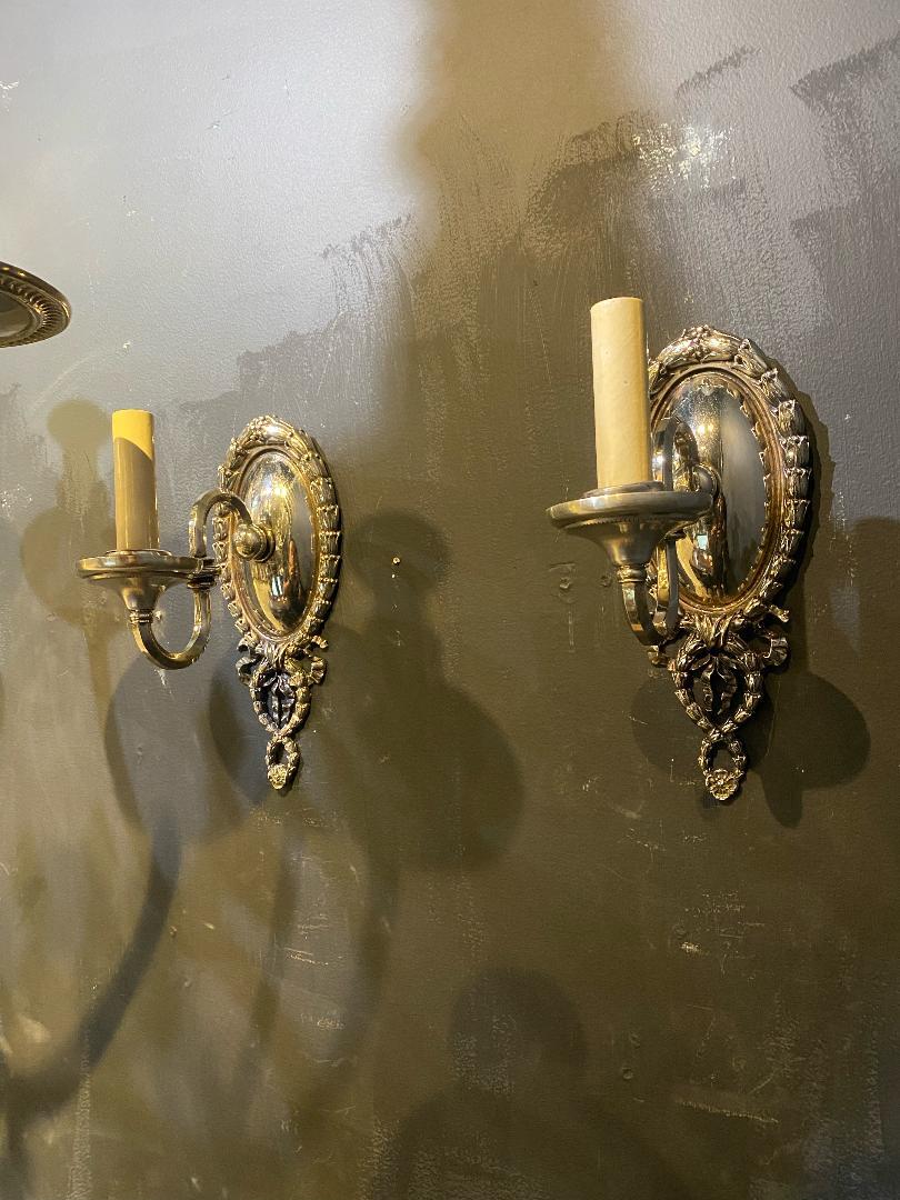 A pair of circa 1920's silver plated Caldwell sconces with one light.