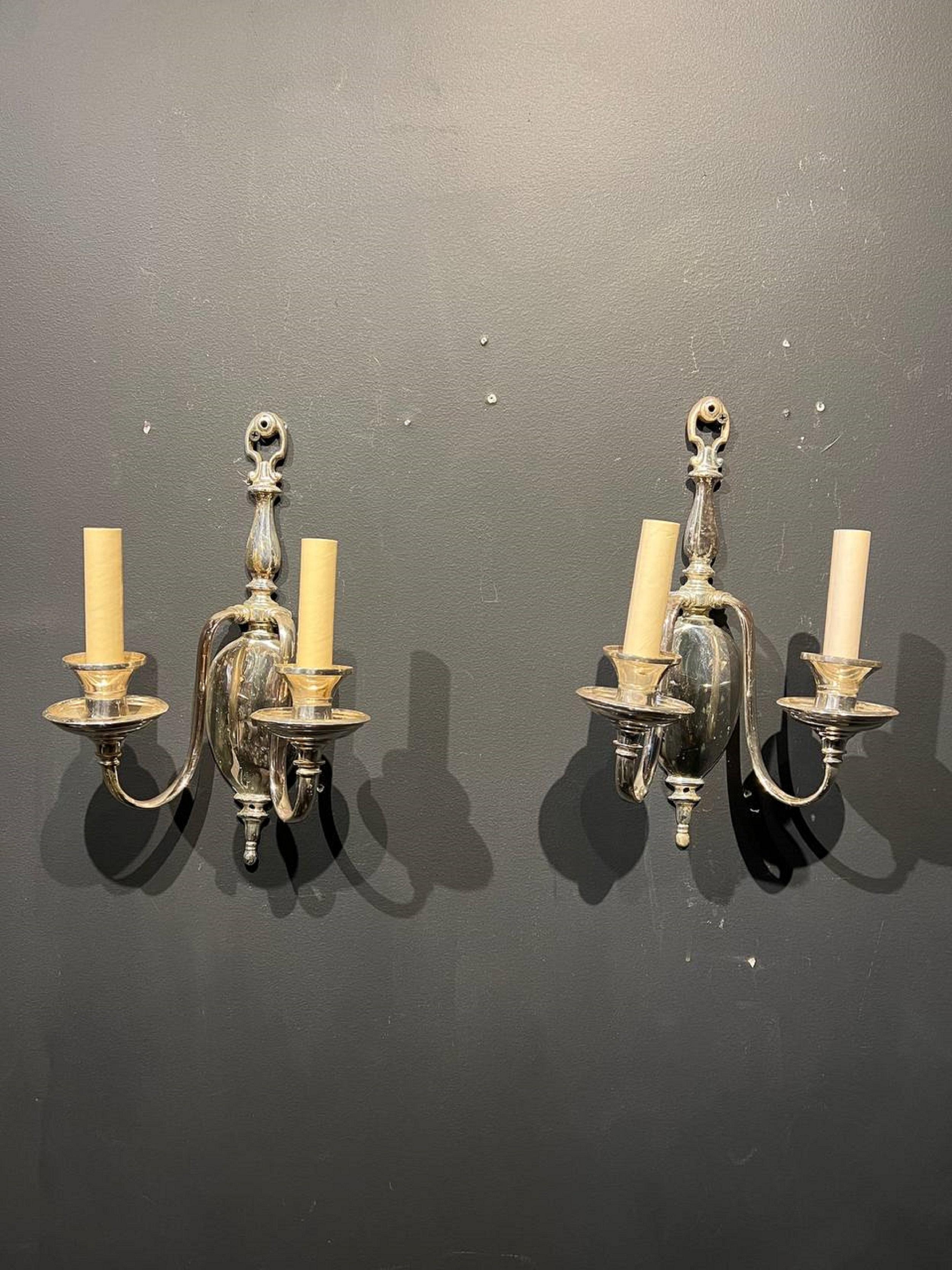 A pair of circa 1920's Caldwell silver plates sconces, traditional style.