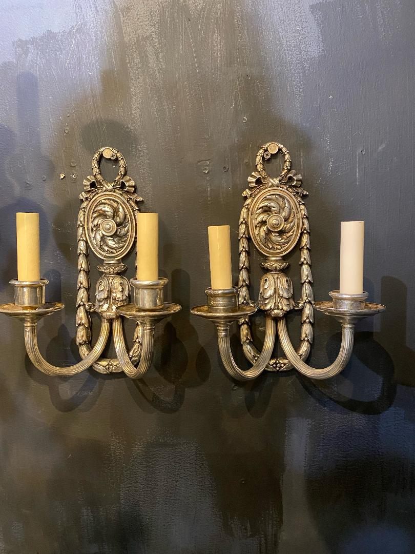 A pair of circa 1920's Caldwell silver plated sconces with two lights 