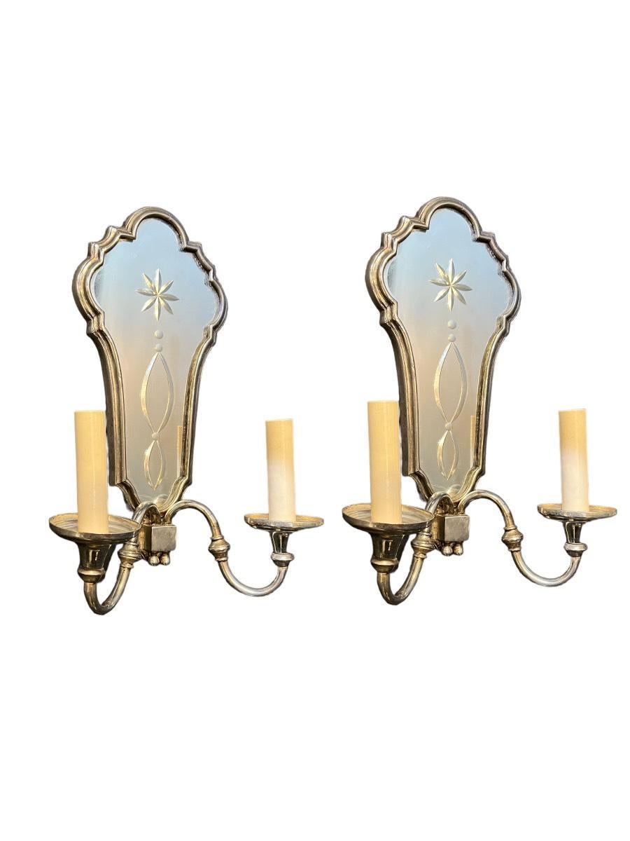 A pair of circa 1930's silvered plated sconces with etched mirrored backplate.