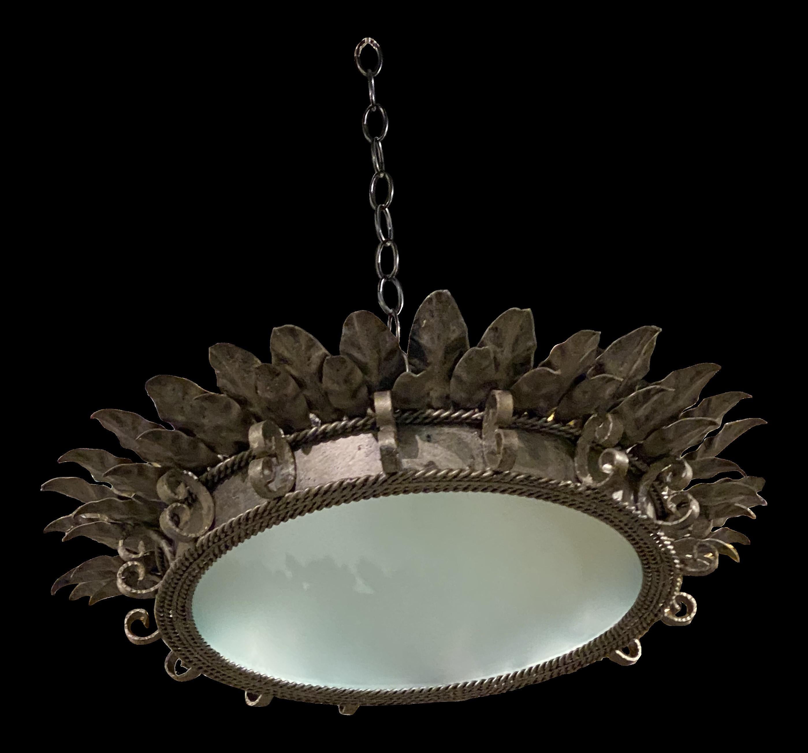 A circa 1930's French silver leafed metal light fixture with glass inset