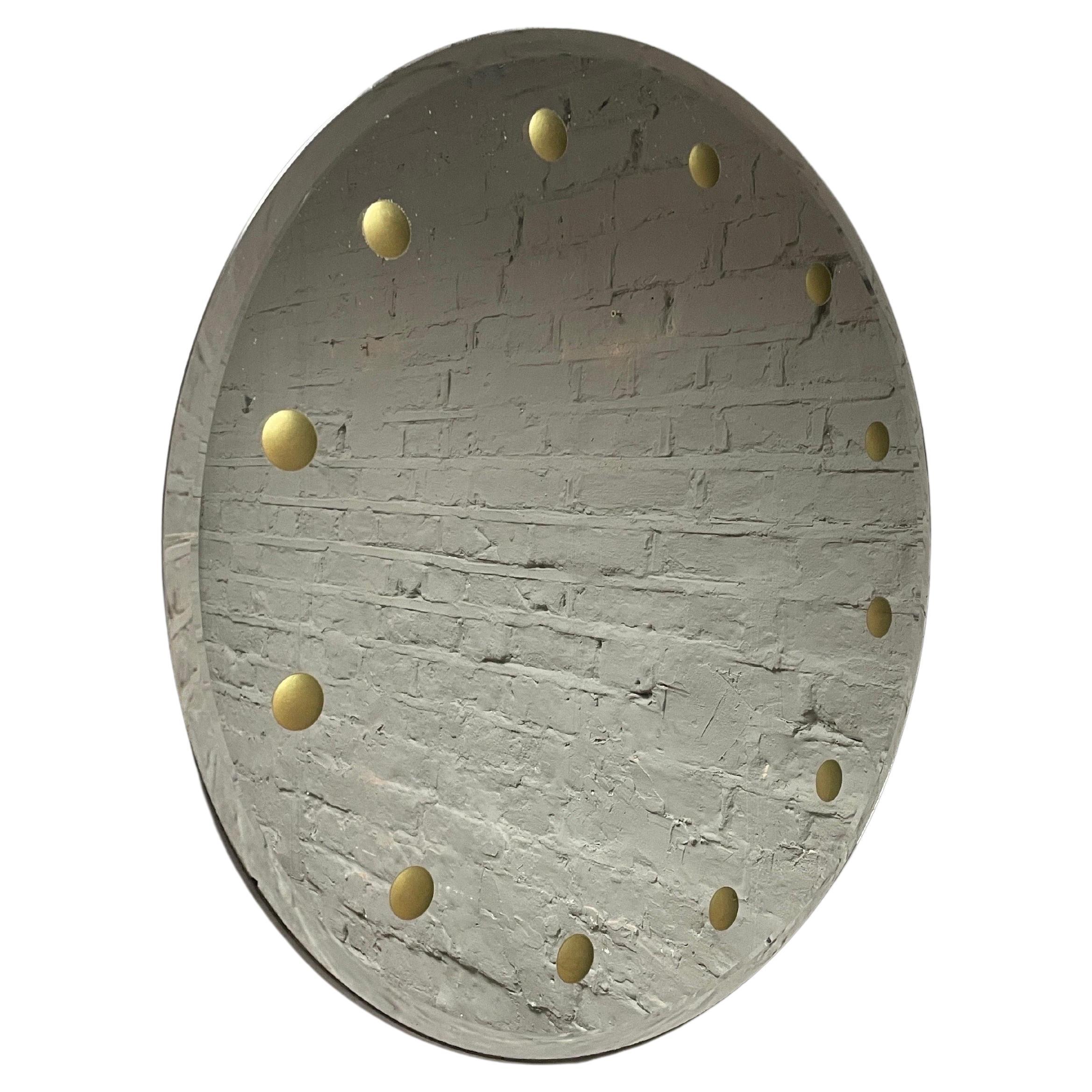 A  miroir circulaire biseauté à décor de sphères en or découpées à l'envers sur le bord extérieur, attribué à Cristal Arte Torino 
