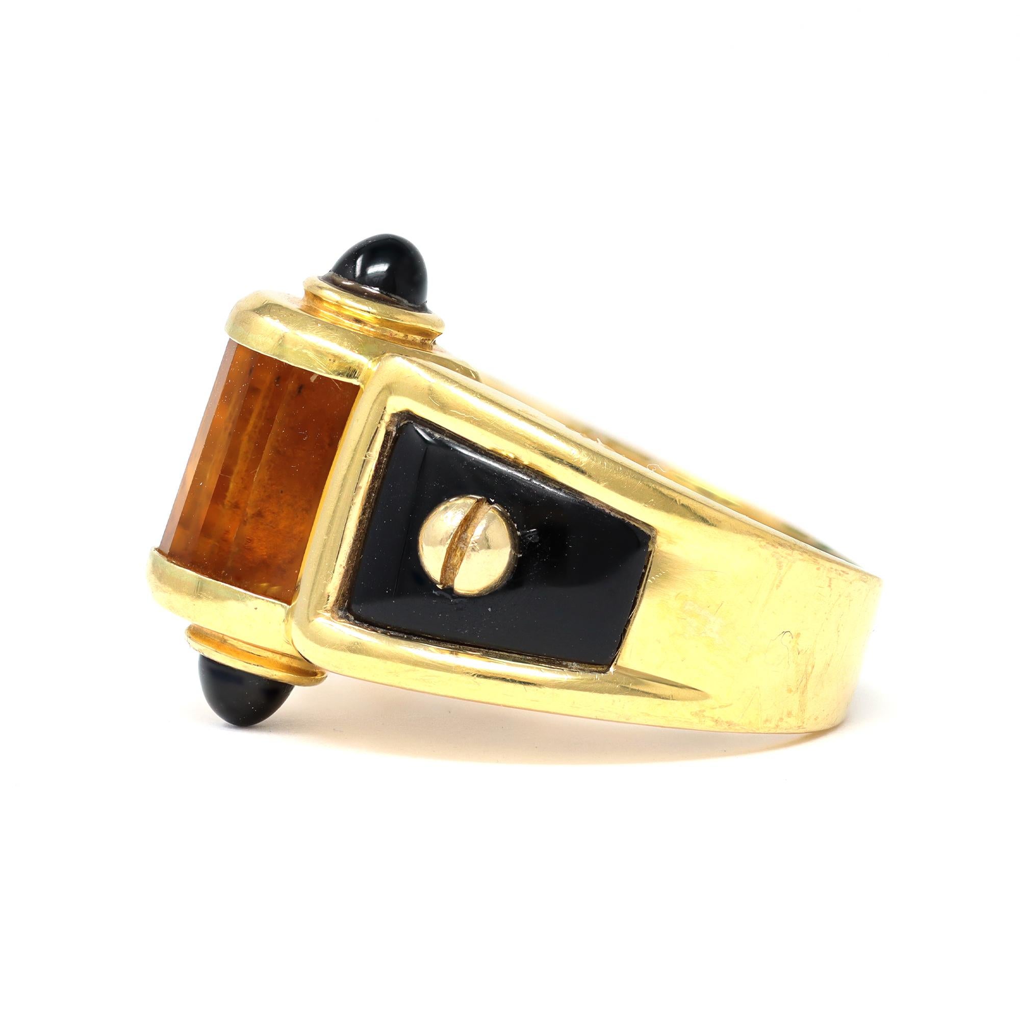 A one of a kind coctail ring circa 1980 featuring a fancy cut citrine and onyx parts, set in 18 karat yellow gold. The gross weight of the ring is 15.4 grams. The ring fits a size 8. It measures 0.77