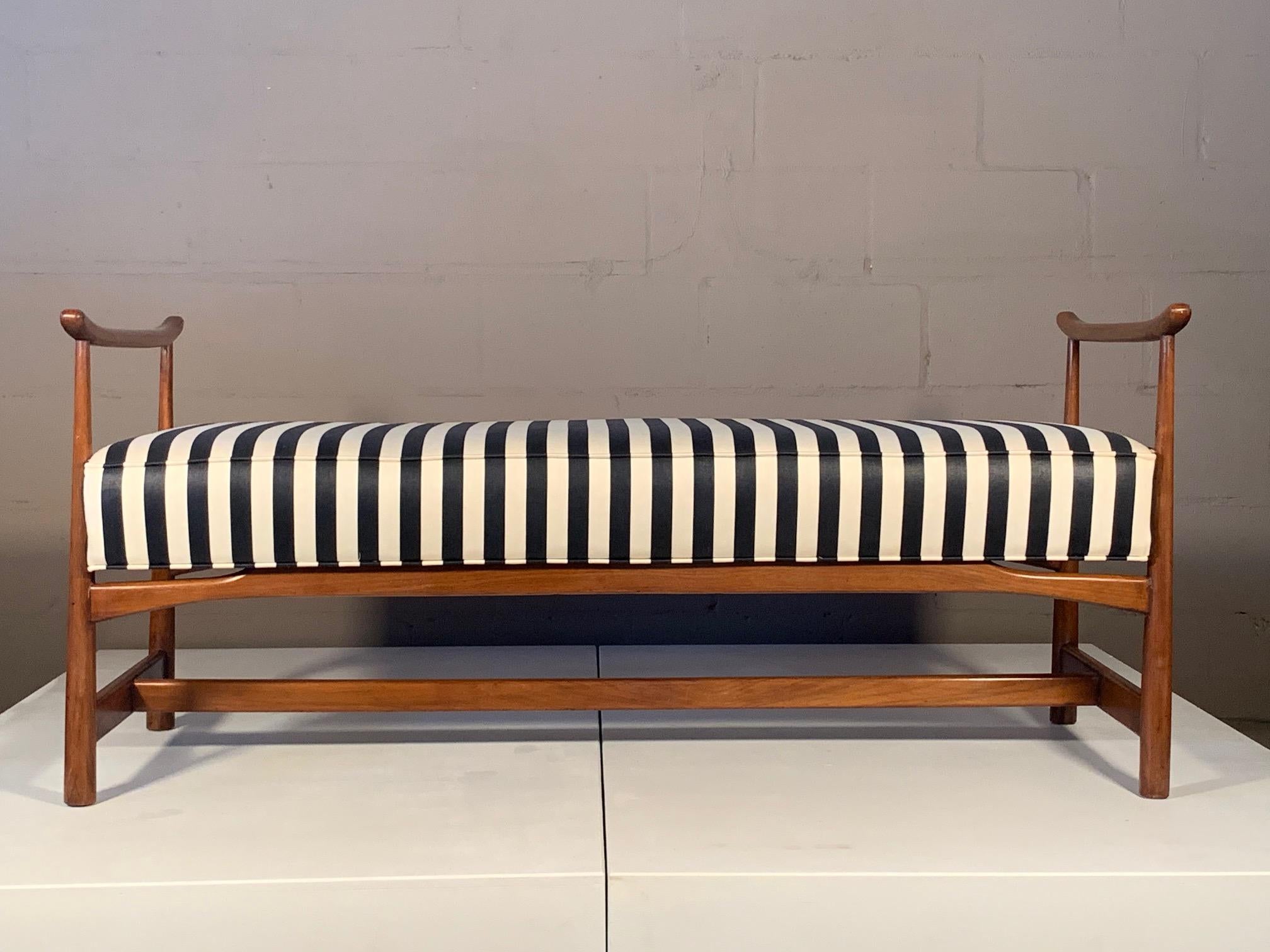 A Classic Asian or Chinese style bench, in walnut. Reupholstered in striped silk previously, walnut frame has a nice patina. Measures approximate 53