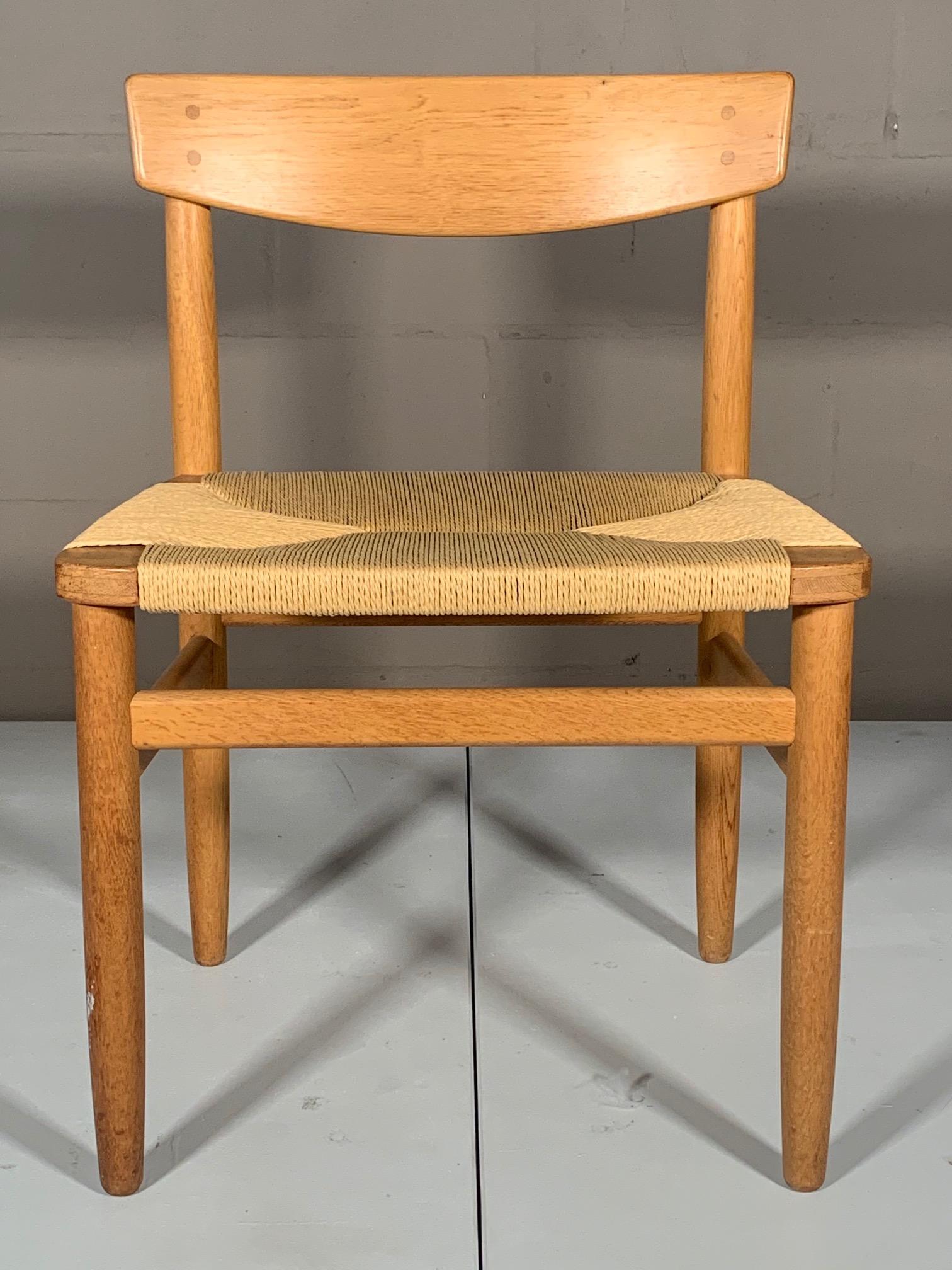 A classic oak and natural rush (papercord) dining or desk chair by Børge Mogensen. Newly redone seat, oak has a nice vintage patina. The chair is comfortable and is wider than most chairs of this style.