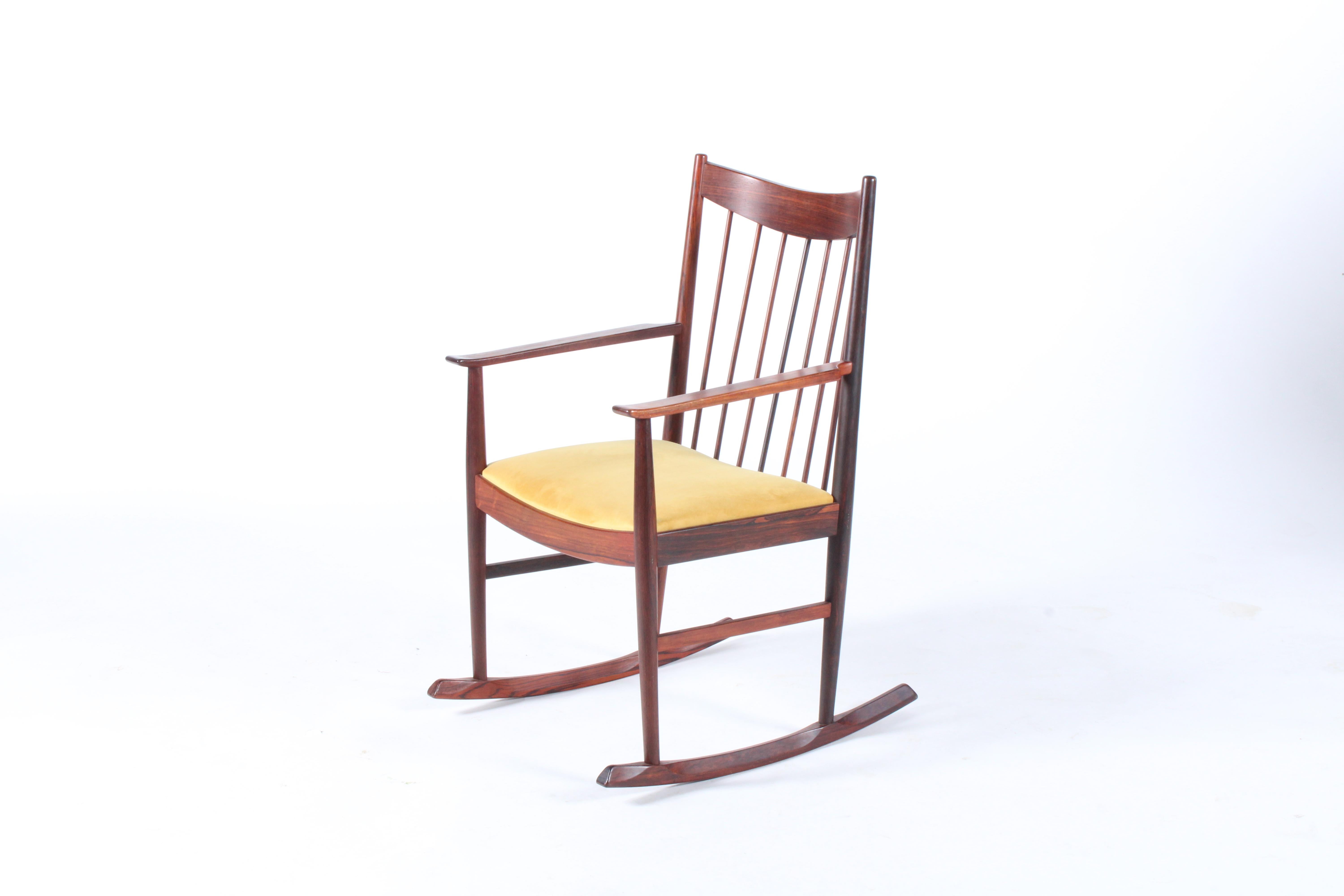 A stunning piece of Danish design, this rocking chair designed by the legendary Arne Vodder for the Sibast furniture company is madre from solid rosewood and we have had the seat newly upholstered in a fine Italian velvet. Sleek and simple lines