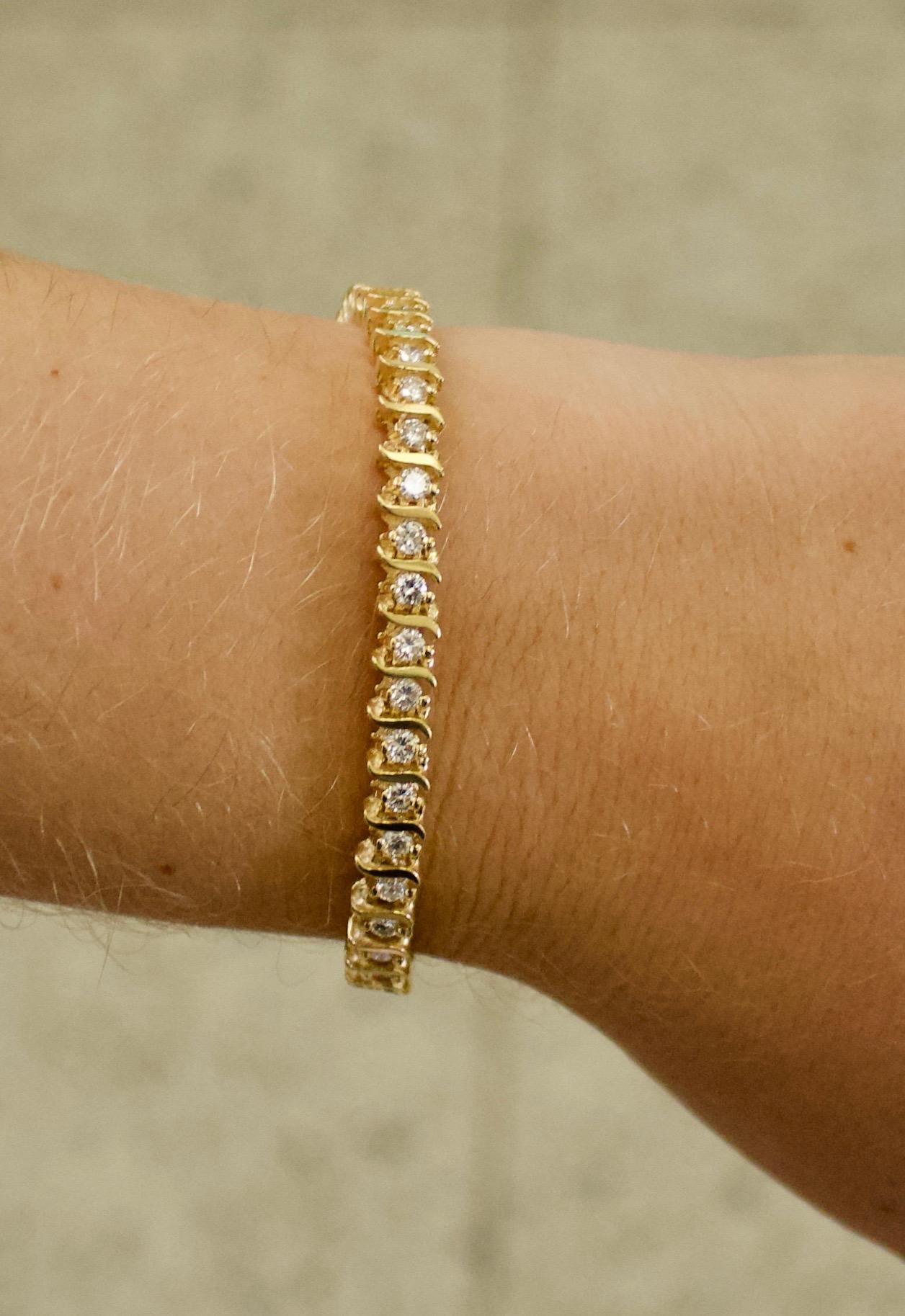 A Classic Diamond Tennis Bracelet in Yellow Gold With Style 3.00 Carats
Forty Four Round Brilliant Cut Diamonds Weighing 3.00 Carats Approximately [GHI  VS-SI1]

Seven Inches in Length 