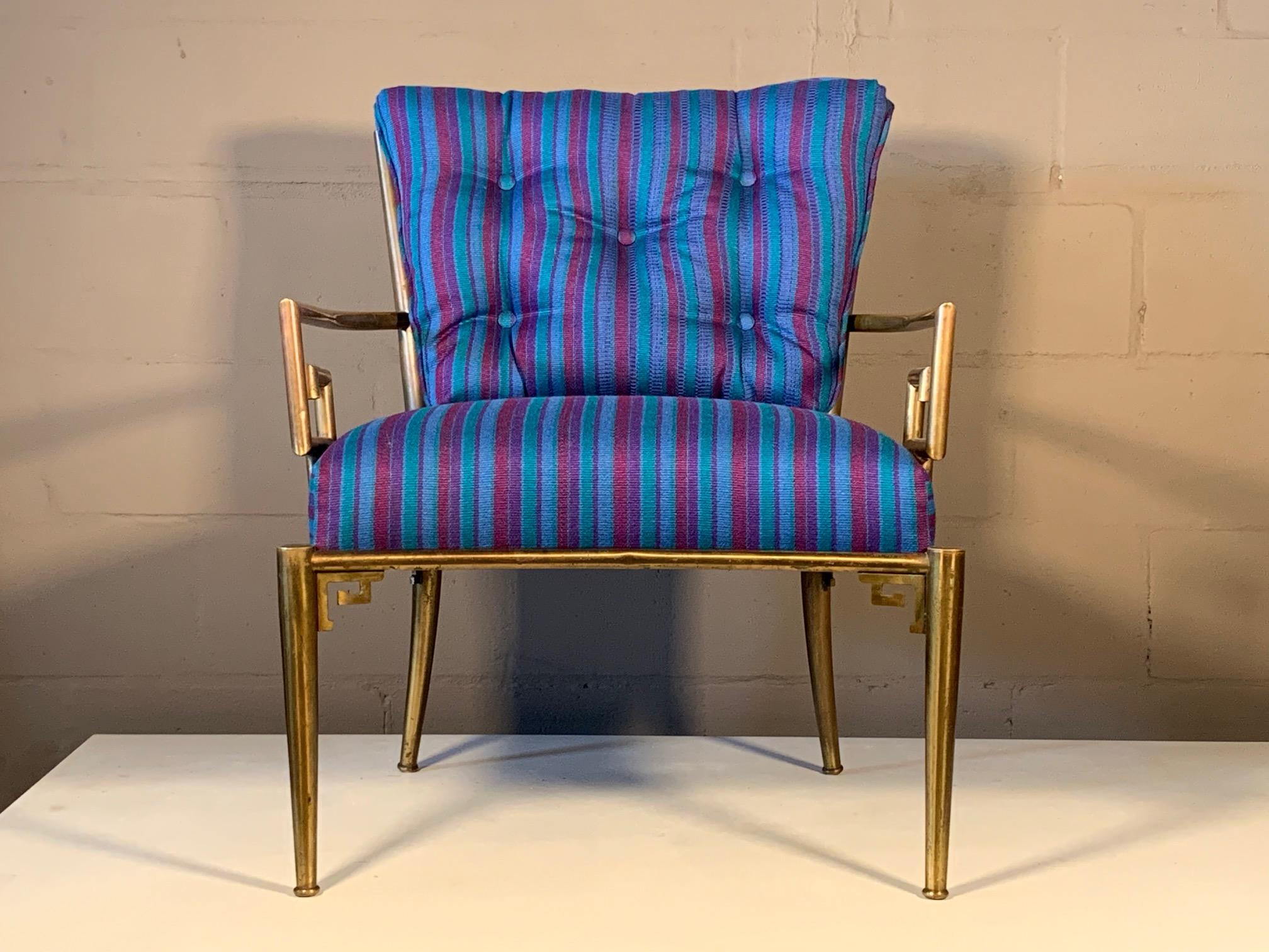 A classic Greek key armchair, made in Italy and distributed by Mastercraft. Made of brass with a curved back, the chair is stylish and very comfortable. Brass frame has patina, upholstery has been redone.