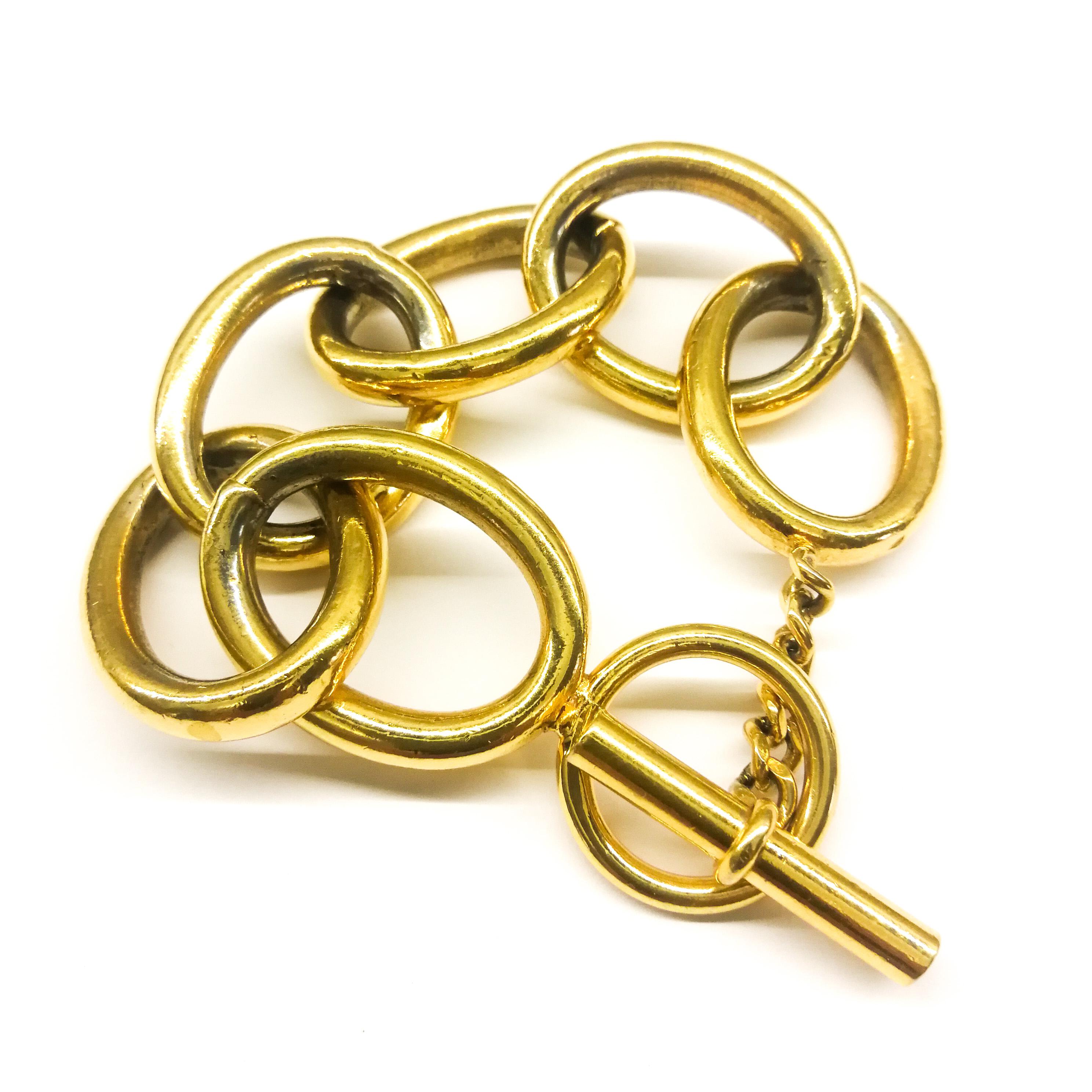 A highly stylish and classic oval link bracelet, in softly gilded metal, from the 1960s by Chanel. Simply marked 'CHANEL' , this bracelet was made by Maison Goossens for Chanel,  a classic signature piece, with a simple but secure bar and circle