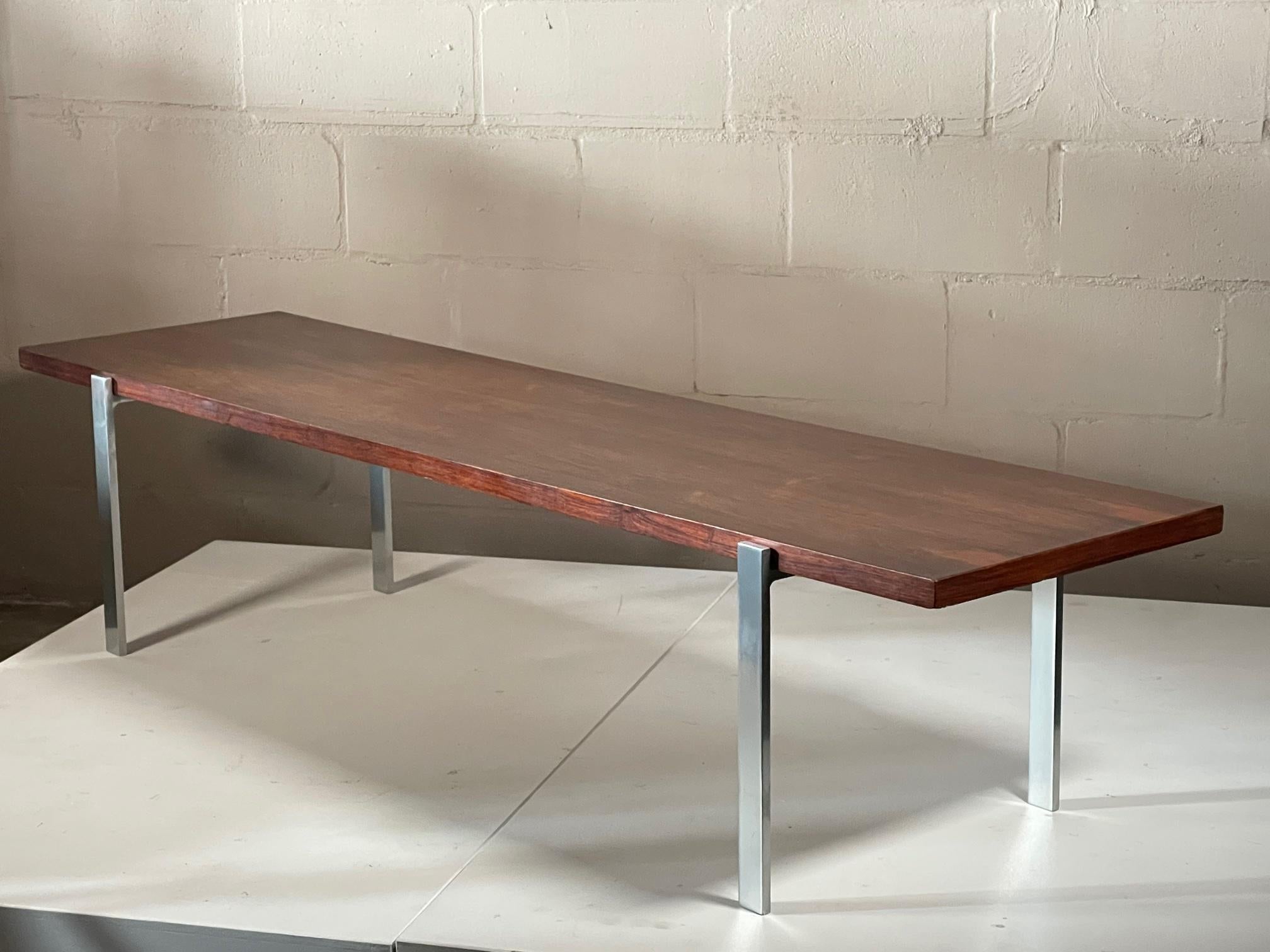 A Minimalist vintage bench or coffee table. Solid steel and rosewood, heavy and well made, circa 1960s. Rosewood top has a nice patina and bookmatched graining.