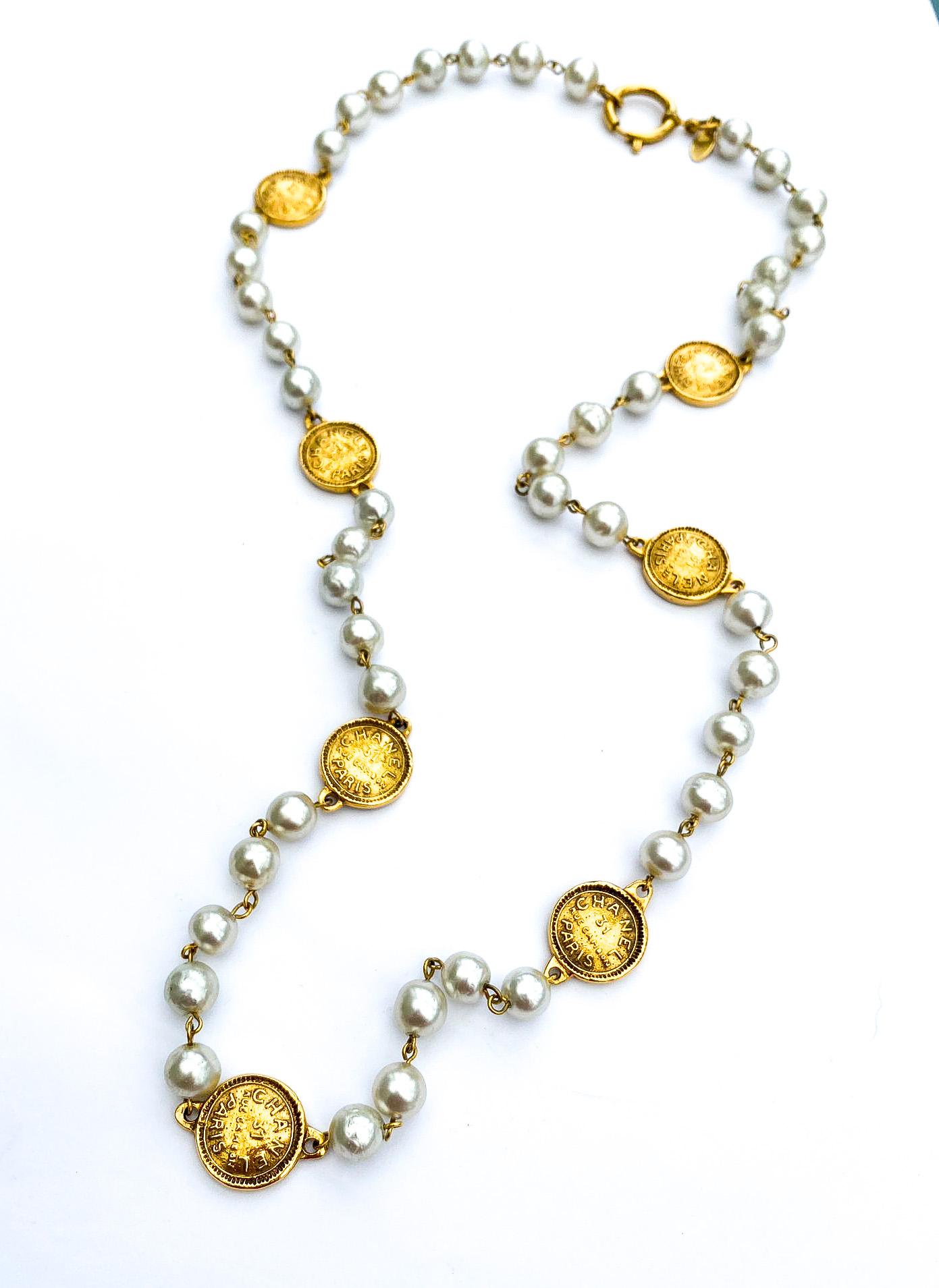 A very classic and very wearable long pearl necklace with 'coin' elements interspersed.  Can be doubled or worn as a long single rope, mixed with other chains or simply worn on its own. Fromm the reign of Karl Lagerfeld, using highly iconic Chanel