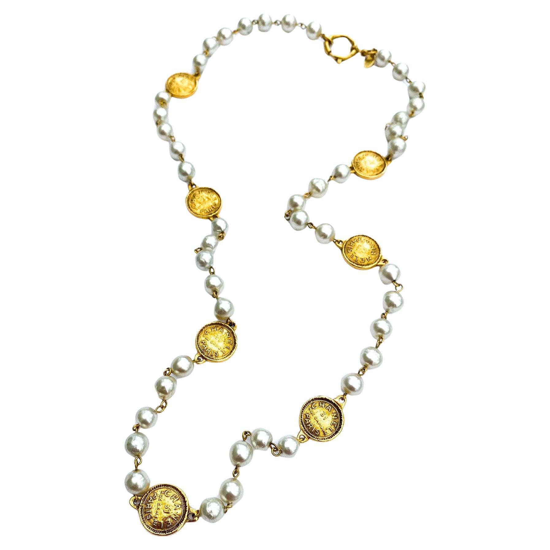 A classic rope of baroque pearls, with medallions/coins, Chanel, Paris 1980s. For Sale
