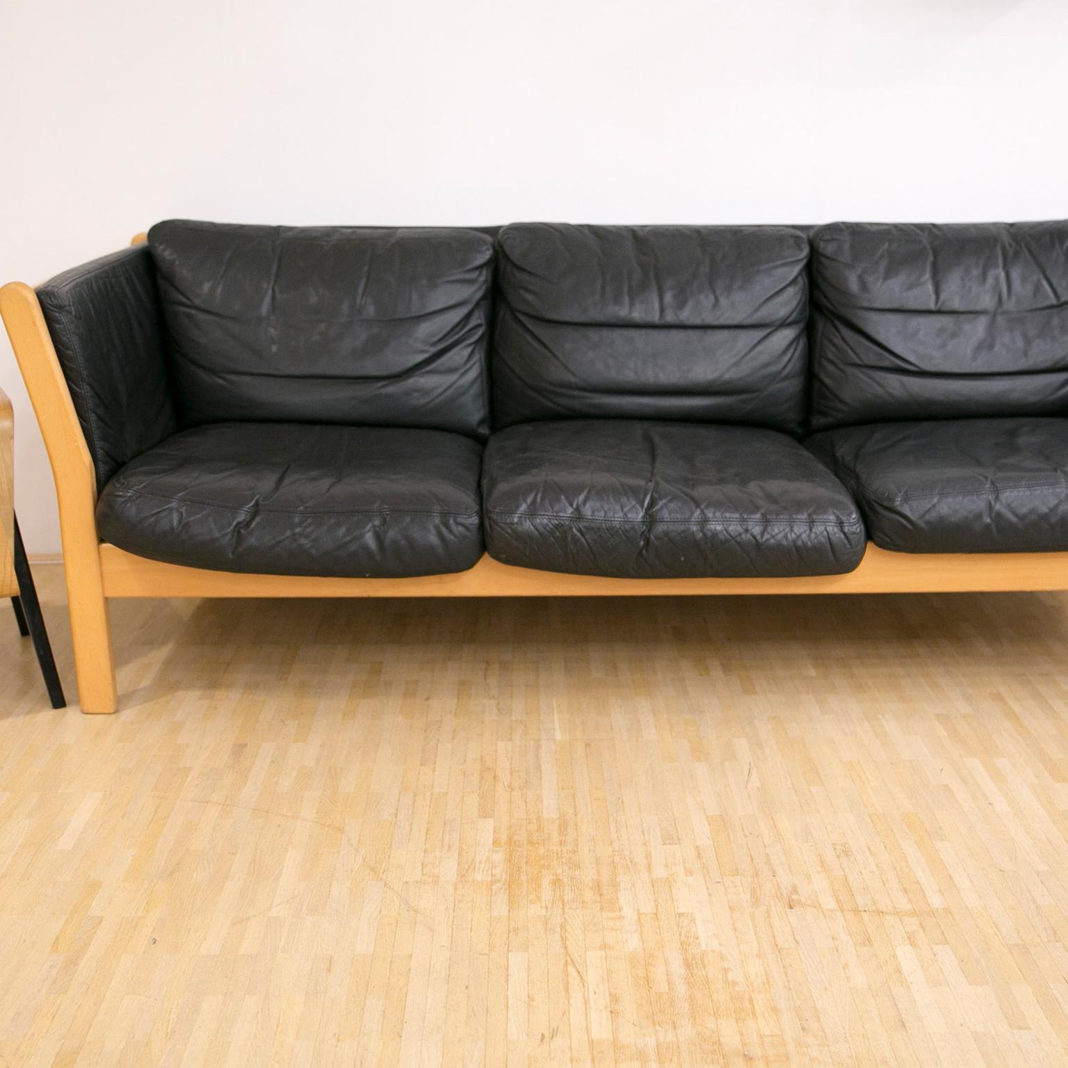 A Classic three-seat in black patinated leather. Classic, solid and timeless piece of design from Denmark.

Measures: H 70 cm x W 208 cm x D 80 cm.