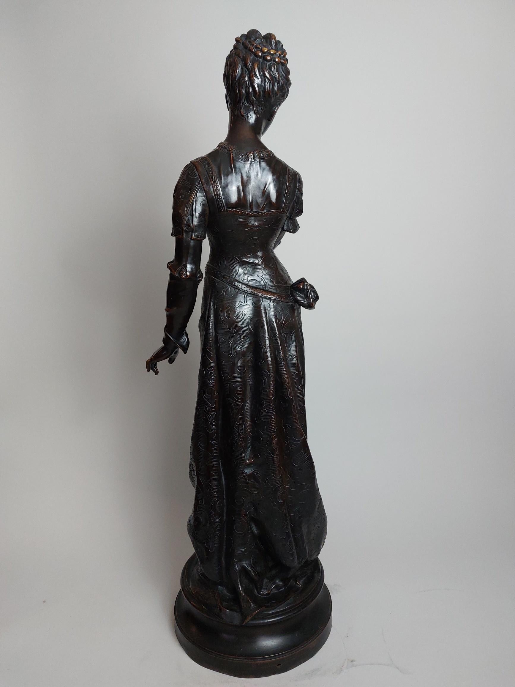A classical 19th century French bronze titled ‘Autumn’ signed Detrier.

She stands in classical garments, with one hand quizzically raised to her chin.

Pierre Louis Detrier (1897-1922)
Detrier was a French sculptor known for his classical