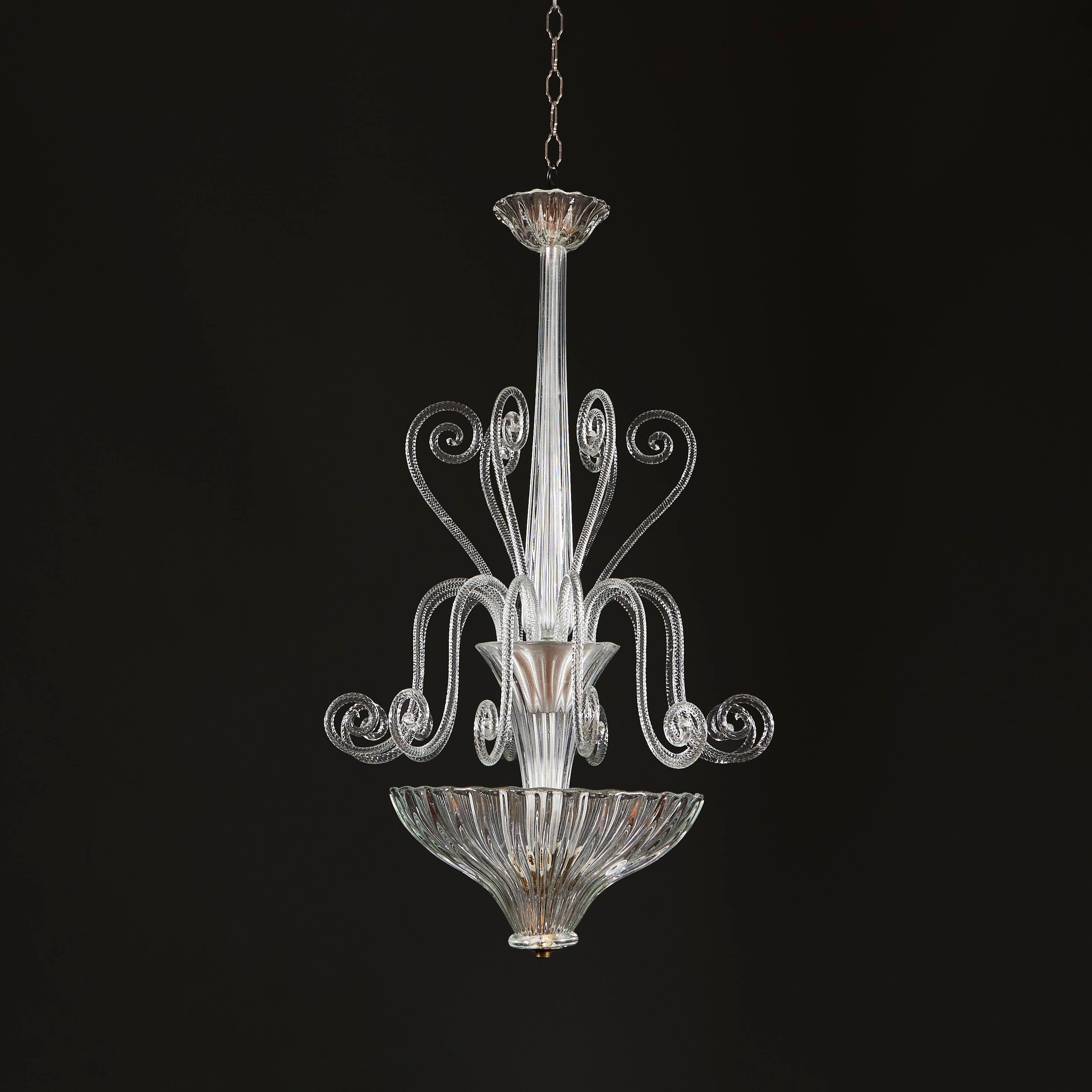Italy, circa 1940

An unusual early twentieth century hanging light with glass fluted stem and unfurling tendrils of foliate form, all issuing from a vase raised above a gadrooned glass dish light. Attributed to Ercole Barovier. 

Height