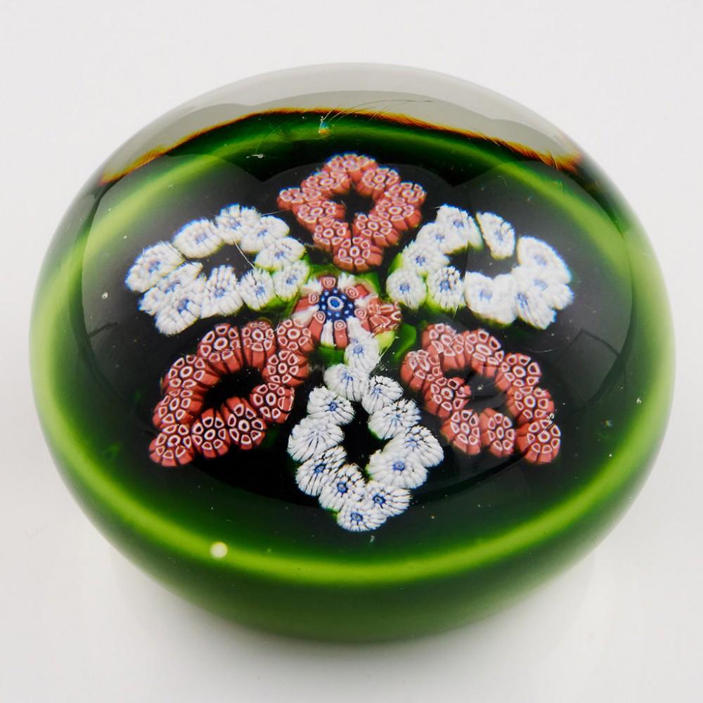 A Clichy Garland Millefiori Paperweight, c1860

Additional information:
Date : c1860
Origin : France
Features : Six elliptical garlands alternating red and white around a central cane, one garland slightly misaligned
Marks : None
Type : Lead
Size :