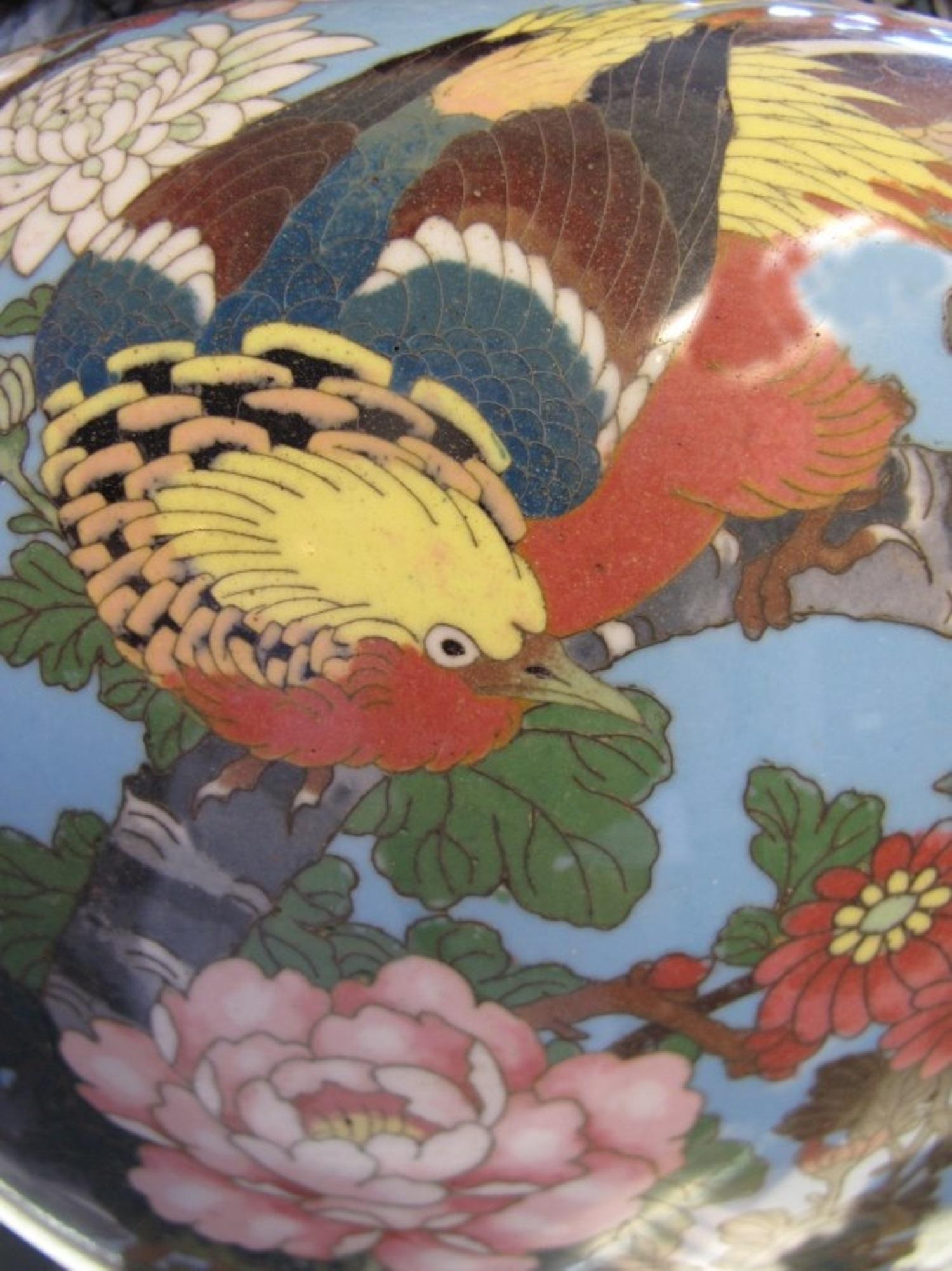 A Cloisonne Enamel Bowl, Chinese, Qing Dynasty.
Set over a spreading foot, the deep body flaring slightly toward the everted rim and set with a pair of chilong-form handles, the sides decorated with archaistic motifs and scrolling lotus all against