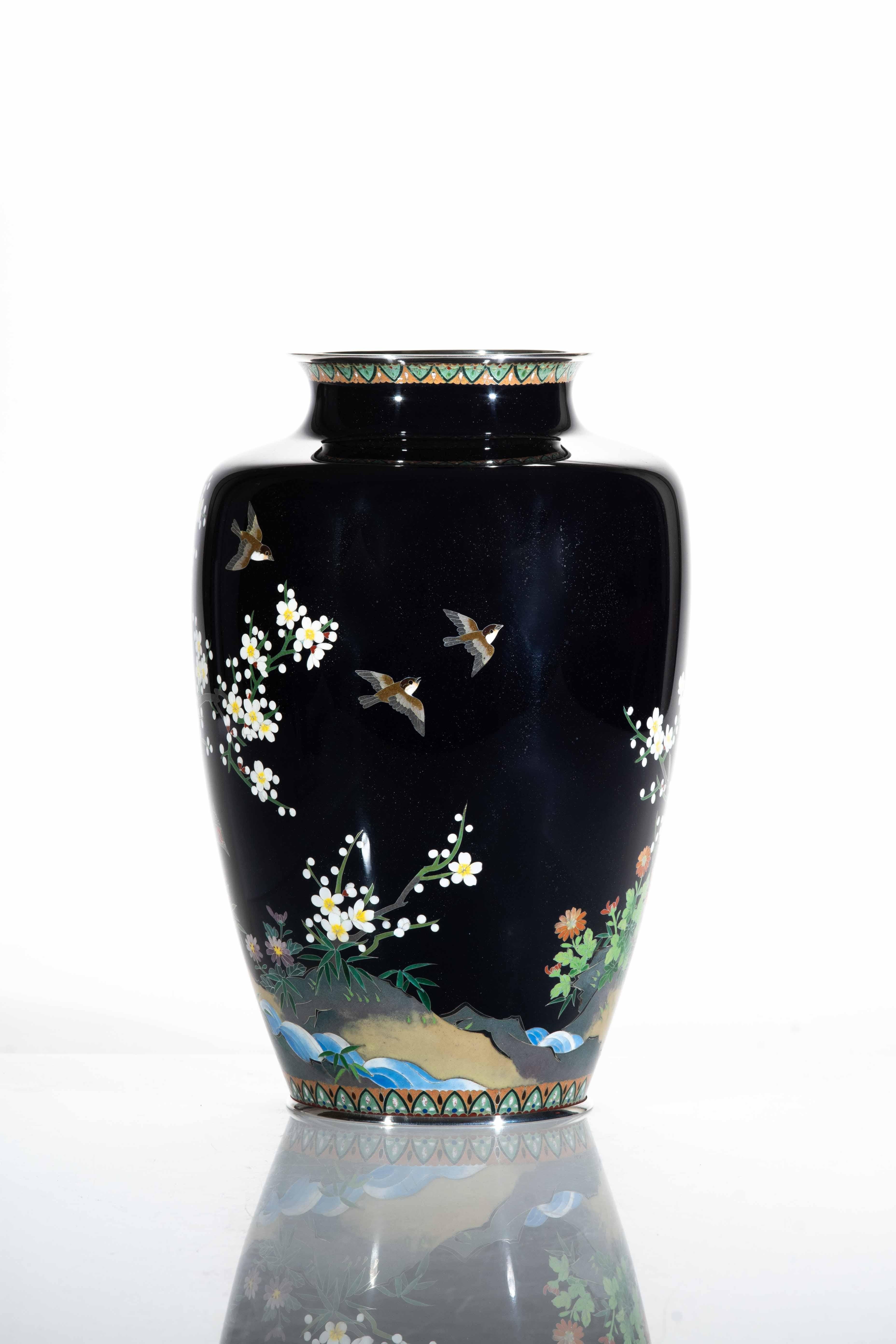 Cloisonné vase, with base and edge in silver, decorated with polychrome enamels held by a silver thread, depicting a pheasant on the banks of a watercourse surrounded by blooming cherry blossoms and chrysanthemums.

The pheasant, chrysanthemums and