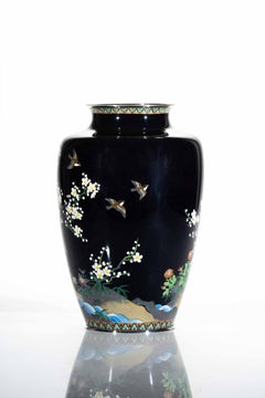 A cloisonné vase depicting a pheasant surrounded by blooming cherry